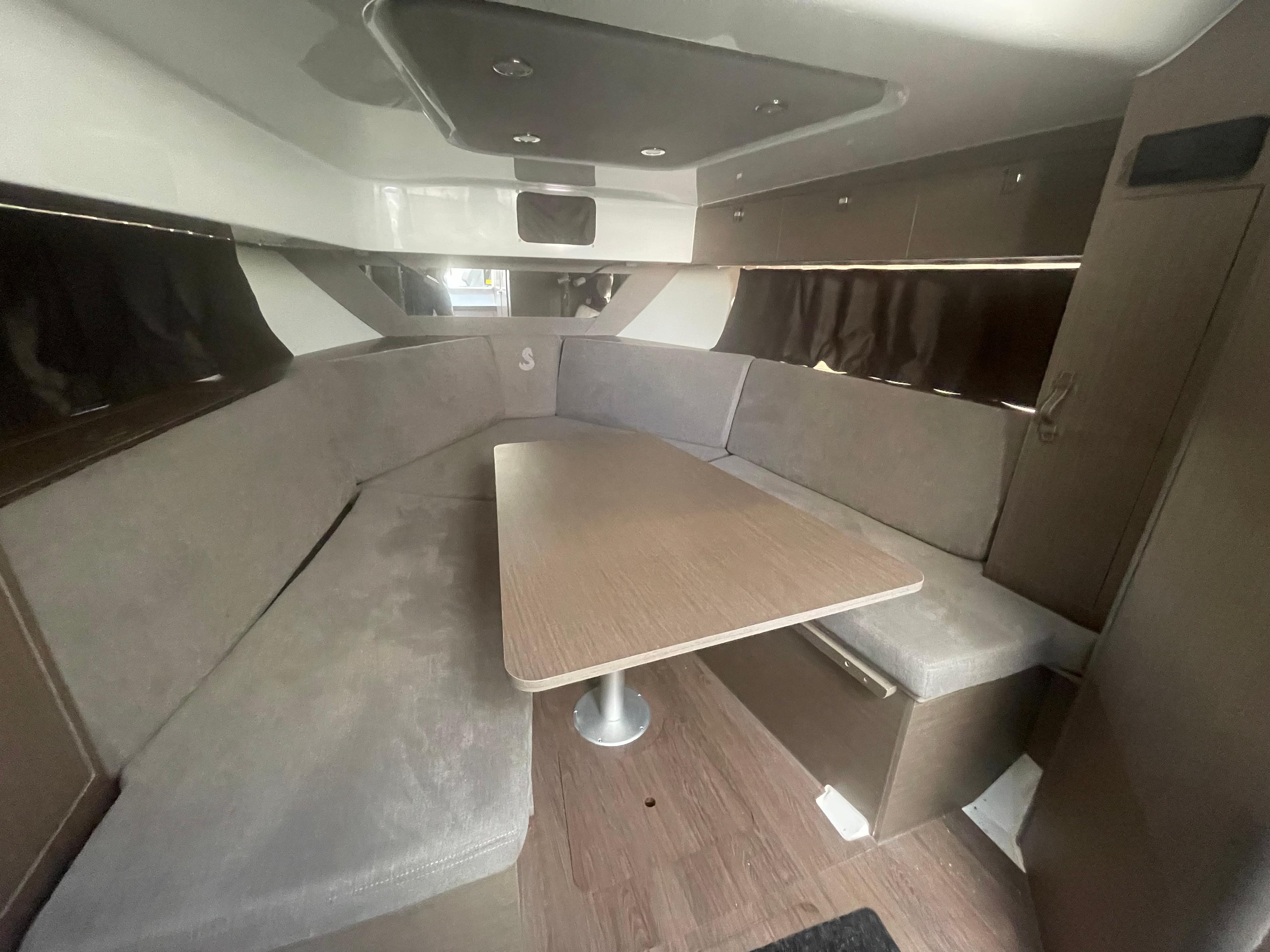 Interior of 2024 Beneteau Gran Turismo 32, featuring a spacious seating area and table.