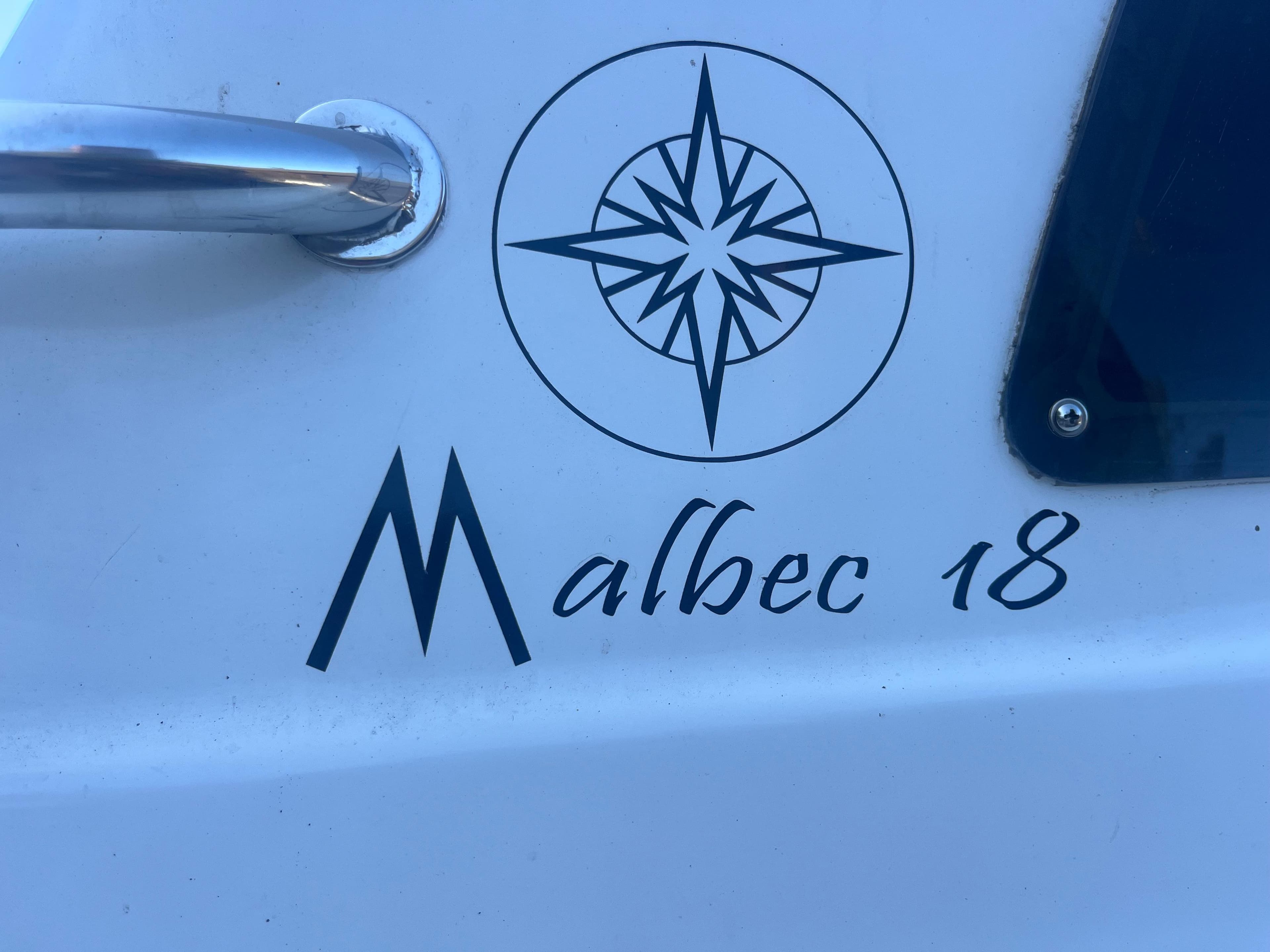 Malbec 18 boat logo with compass design, 2023 model.