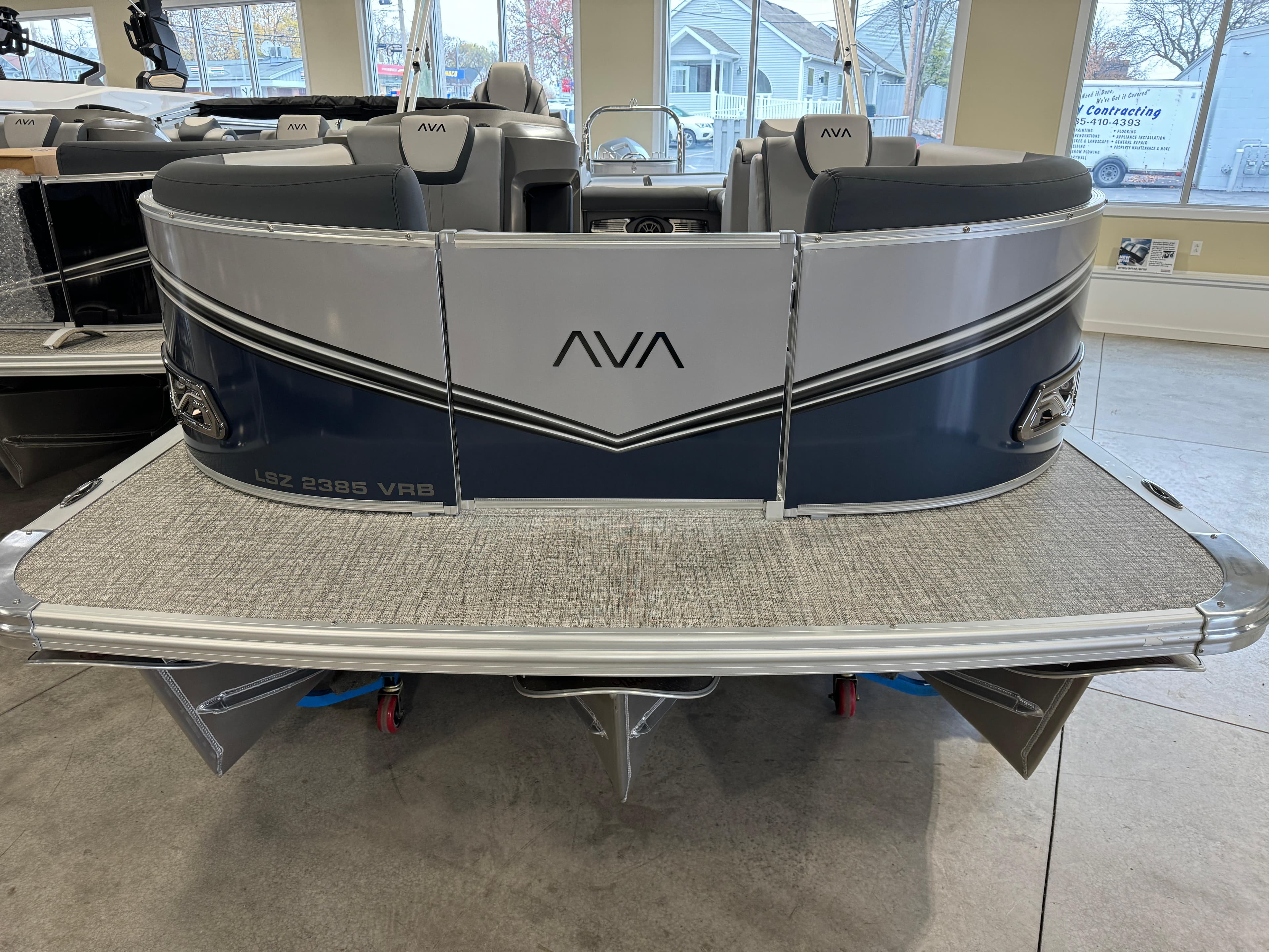 2025 Avalon LSZ VRB pontoon boat displayed indoors, featuring sleek design and comfortable seating.
