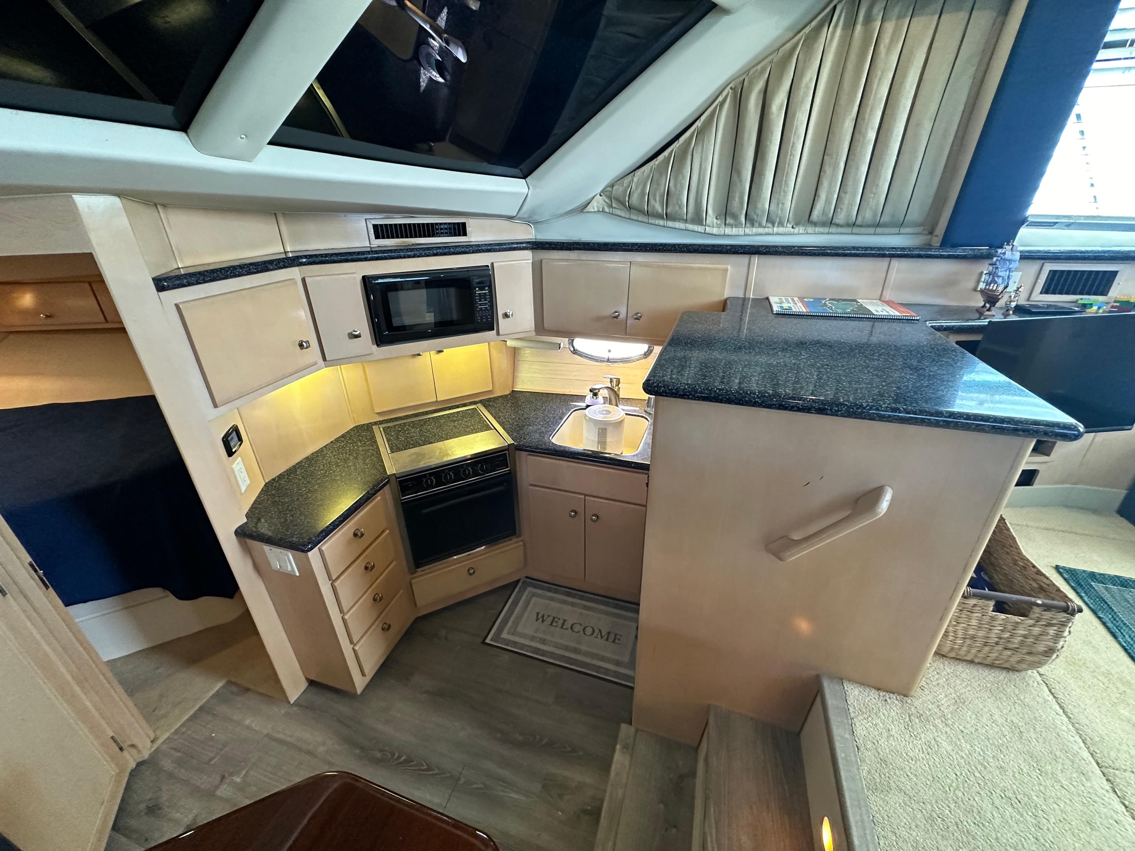 2000 Carver 406 Motor Yacht kitchen with modern appliances and granite countertops.