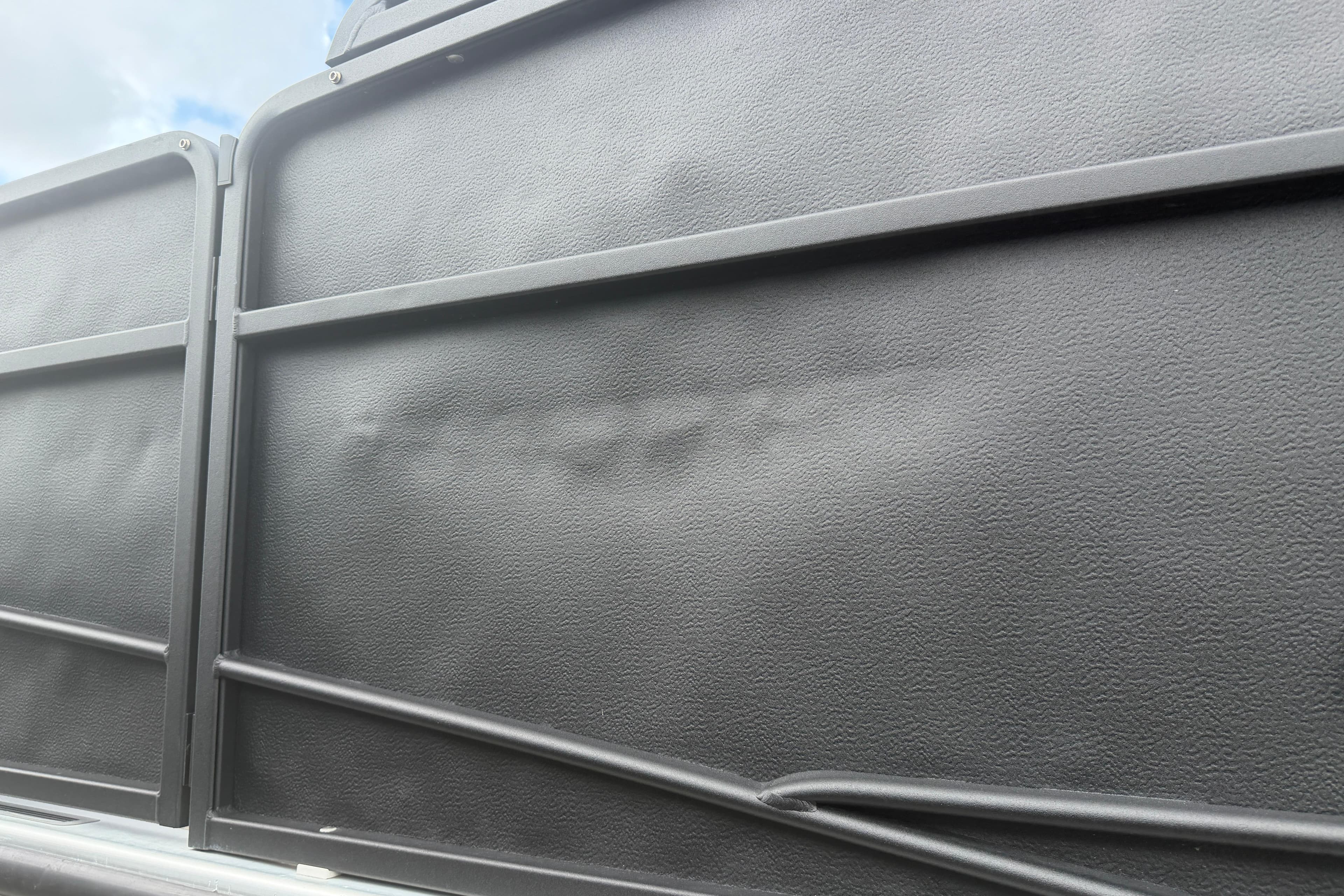 Close-up of a 2015 Premier 290 Grand View boat panel with textured surface.