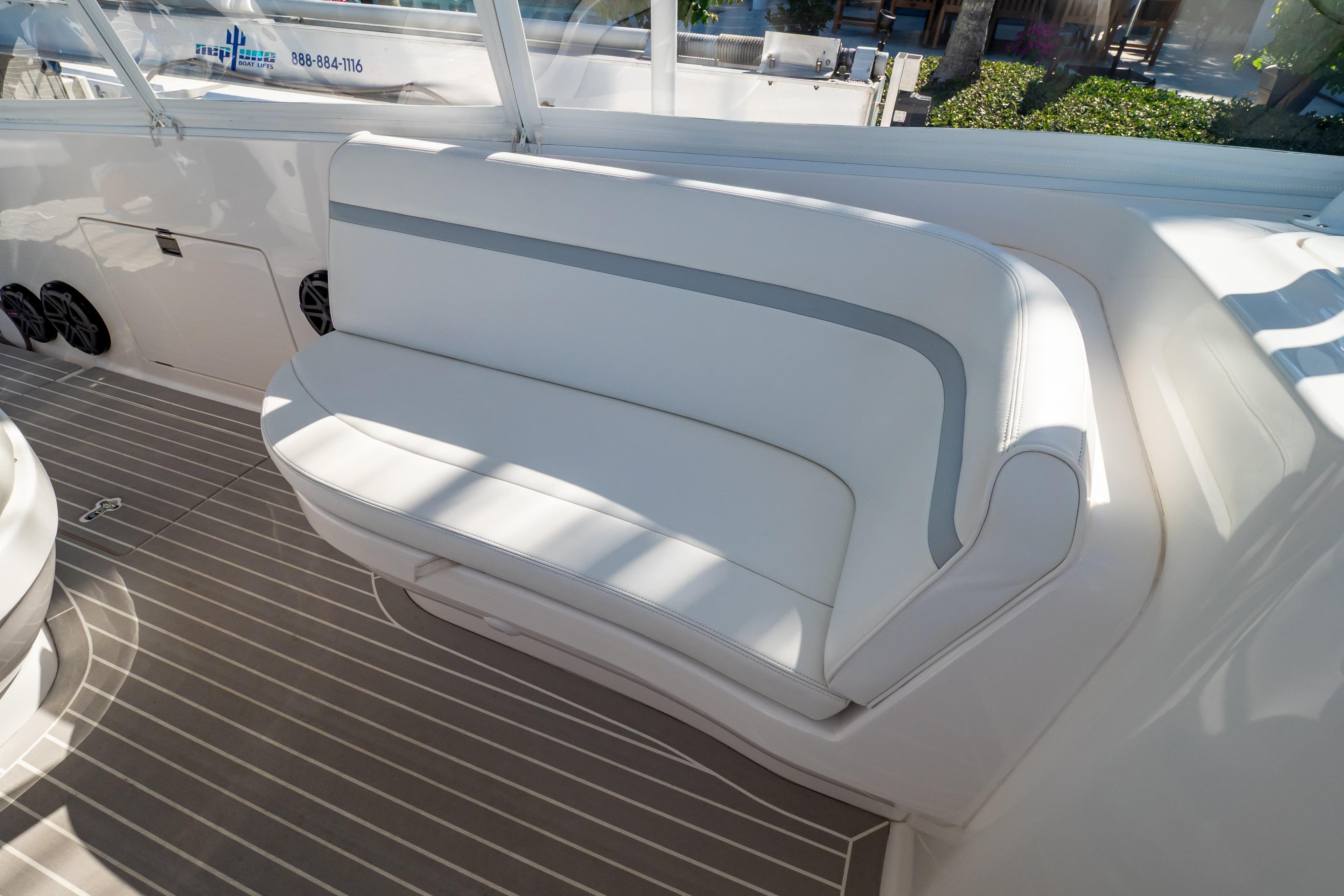 2016 Intrepid 400 Cuddy boat interior with white cushioned seating and striped flooring.