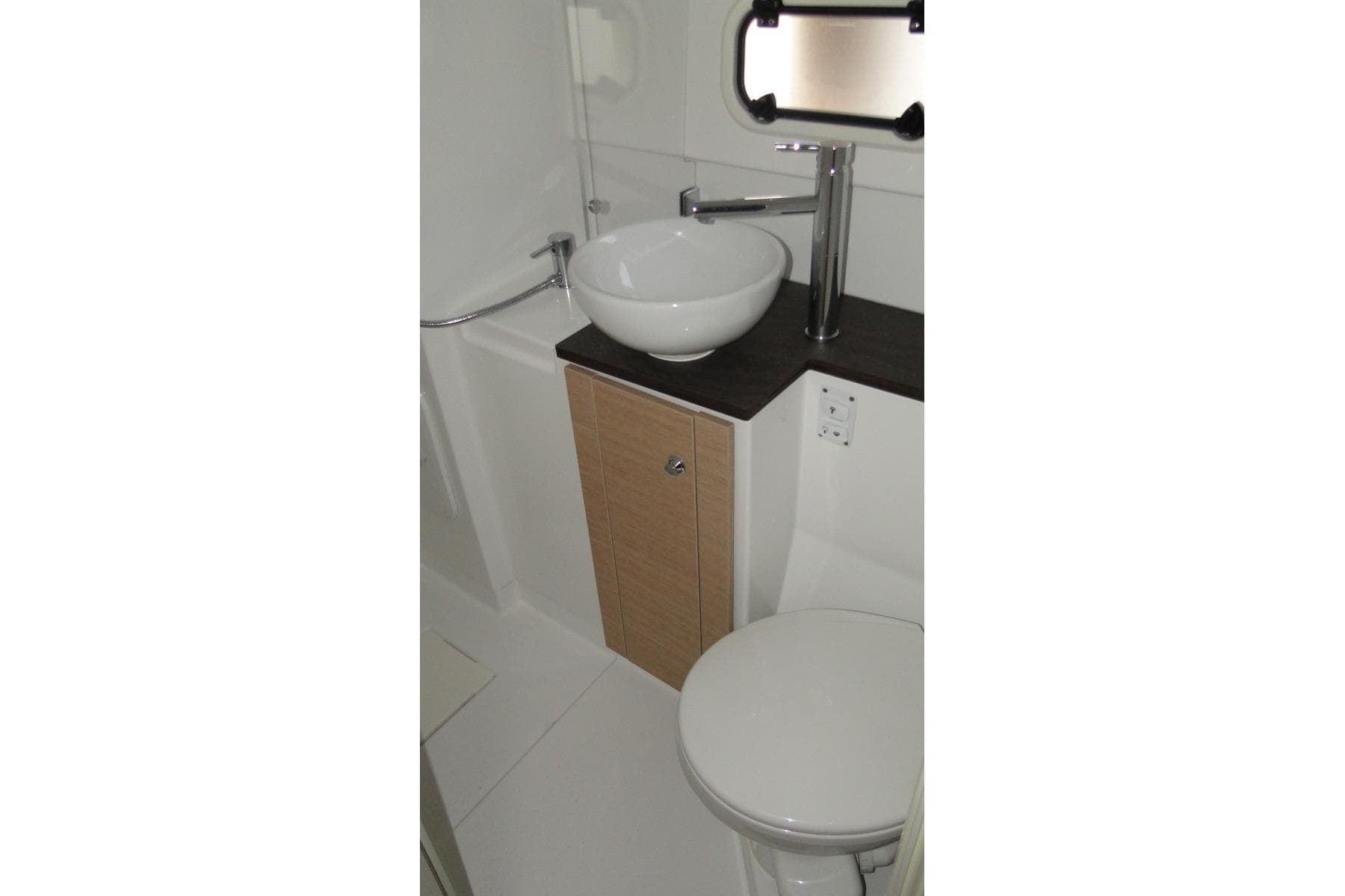 Compact bathroom in 2016 Bali 4.5 model, featuring modern sink and toilet.