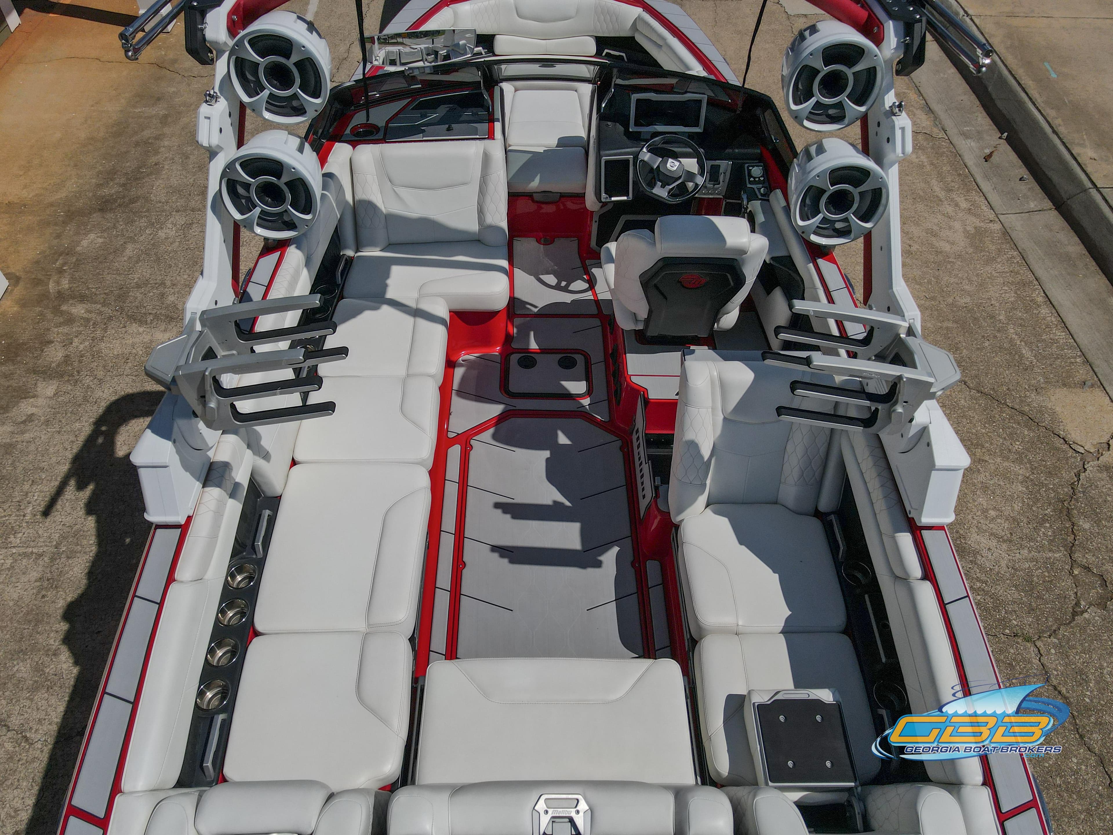 2021 Malibu M240 boat interior with white seating, red accents, and advanced audio system.