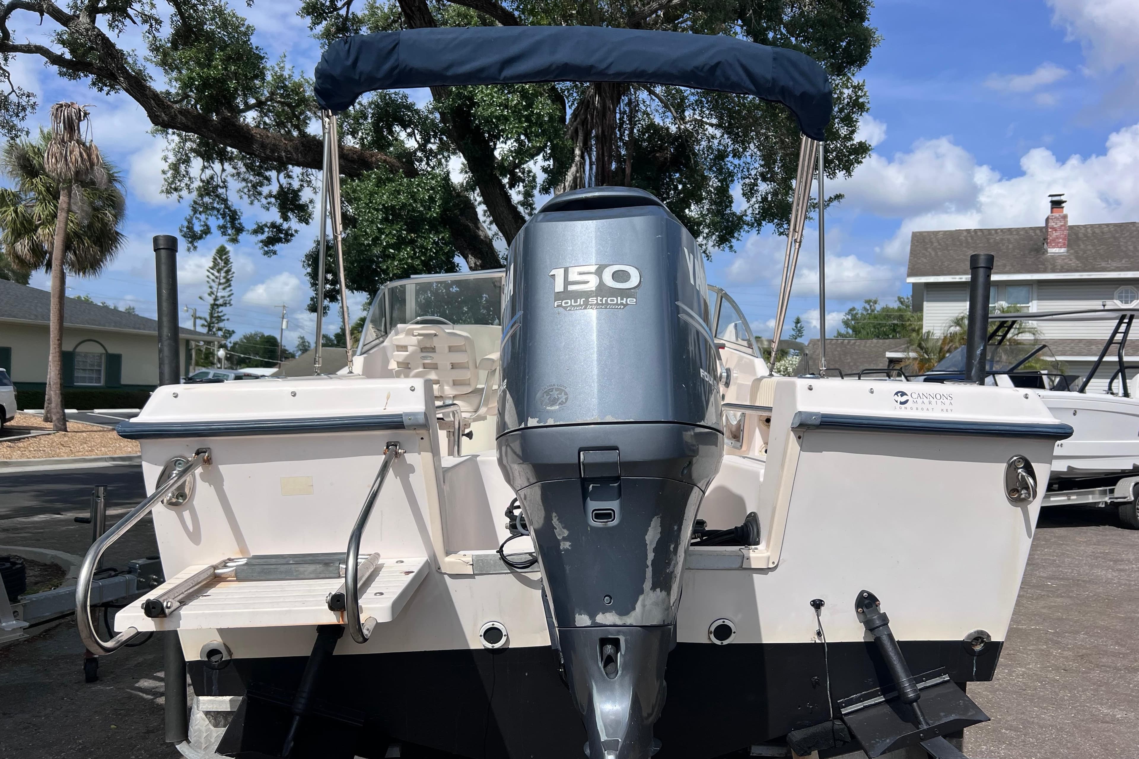 2006 Grady-White Tournament 205 boat with 150 horsepower engine, parked outdoors.