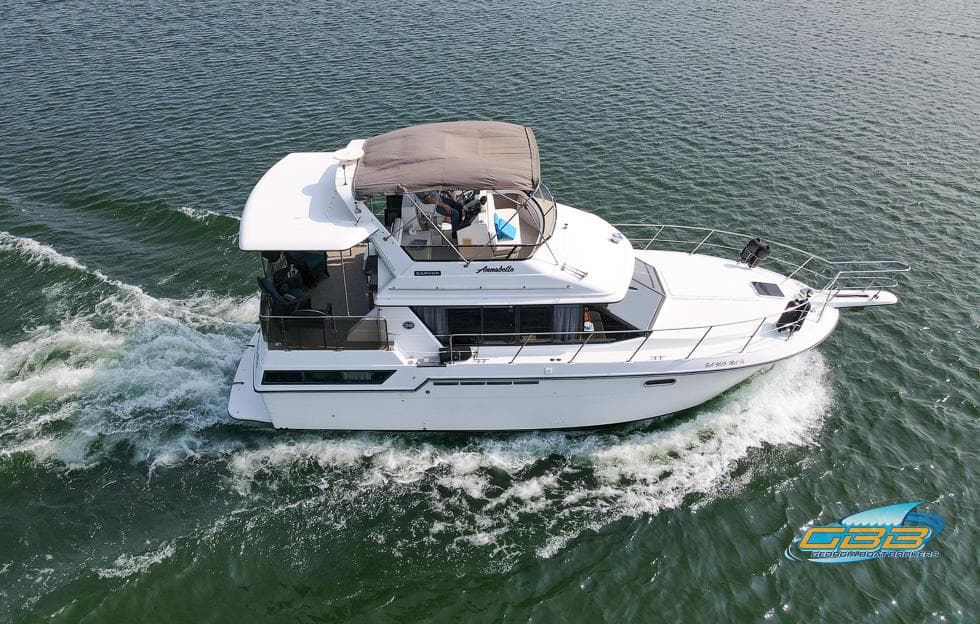 1989 Carver 3807 Aft Cabin cruising on open water, aerial view.