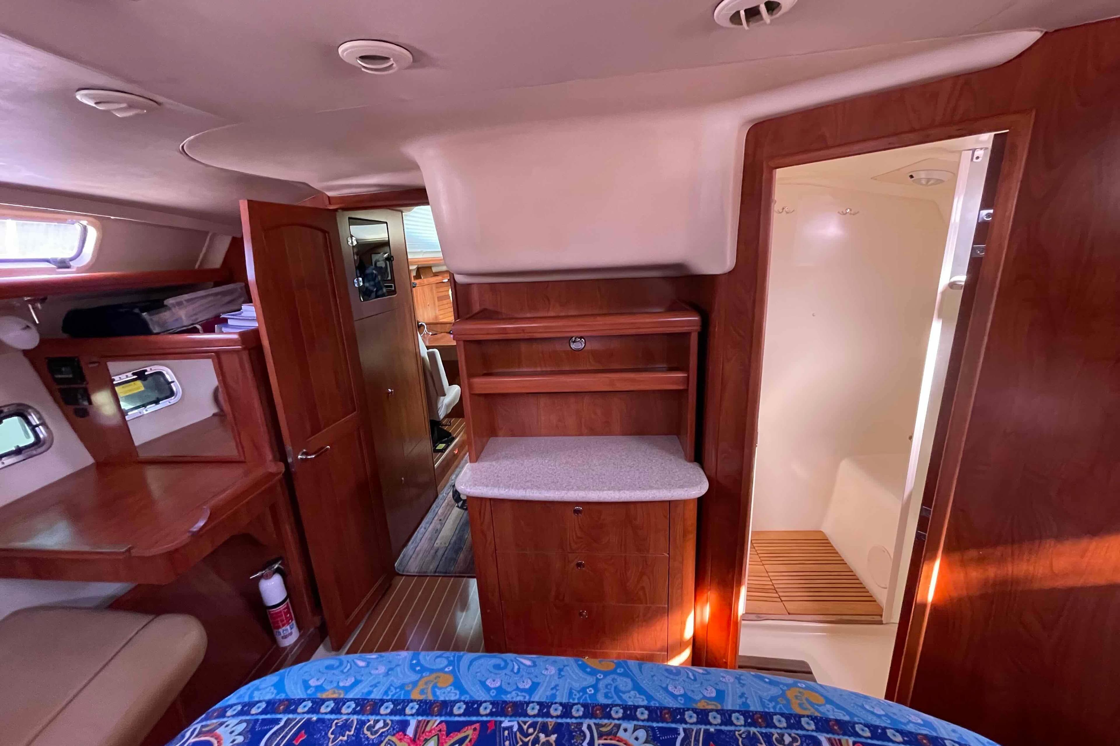 Interior of 2010 Hunter 45 Center Cockpit yacht with wood cabinetry and cozy design.
