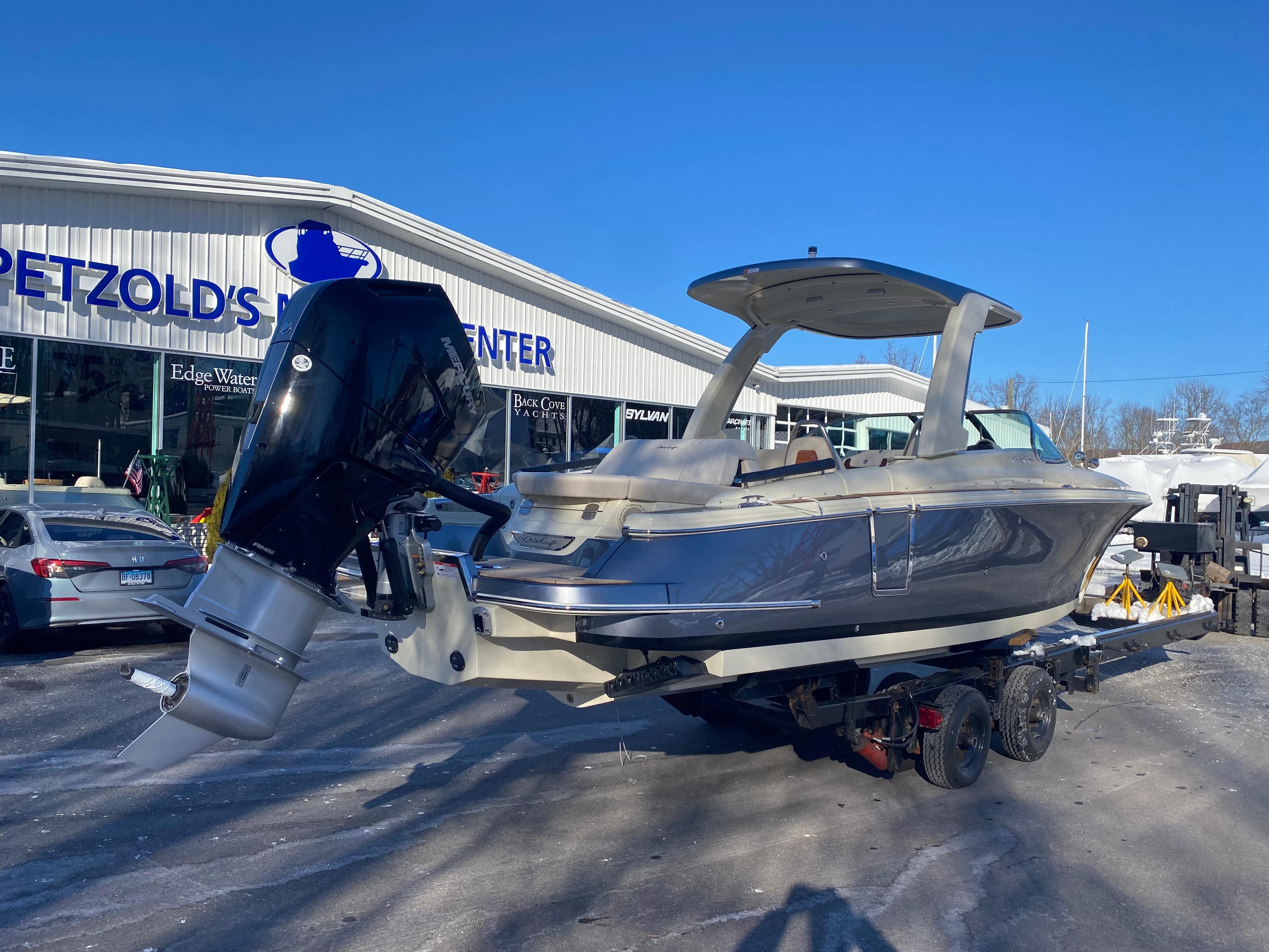 2025 Chris-Craft Launch 28 GT boat on trailer at dealership.
