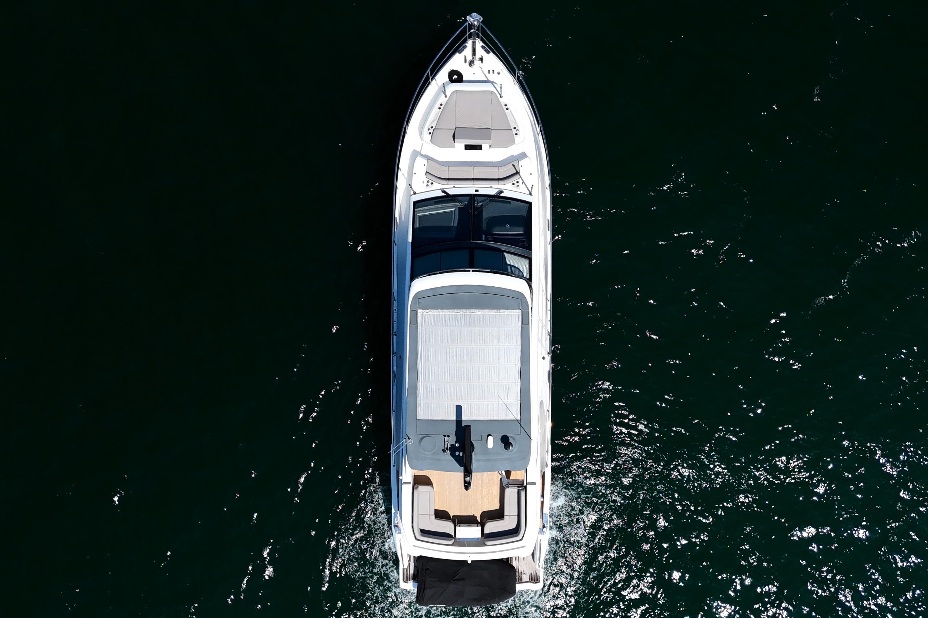Aerial view of 2022 Pearl 62 yacht cruising on dark water.