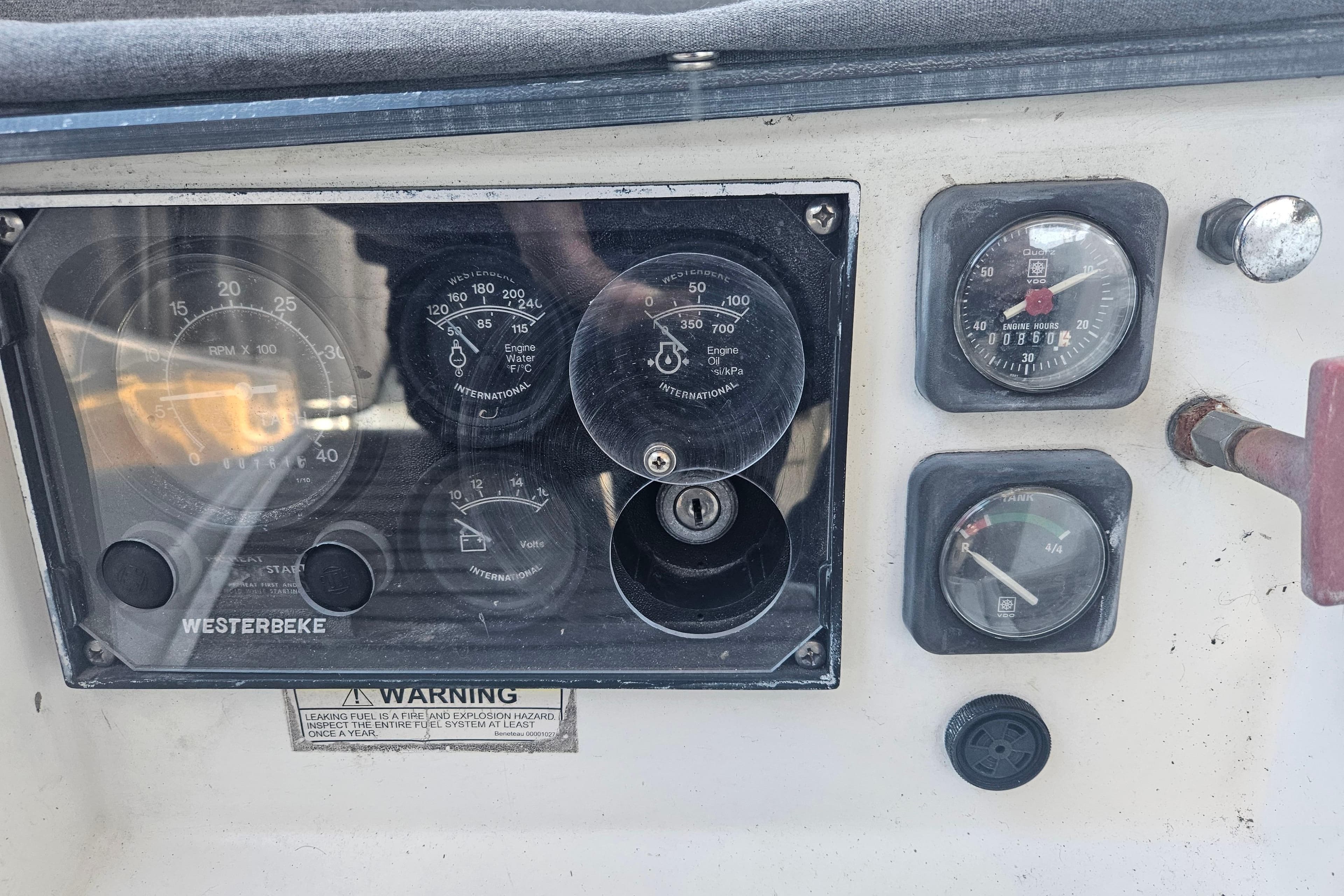 Control panel of a 1998 Beneteau 381 sailboat with gauges and key ignition.