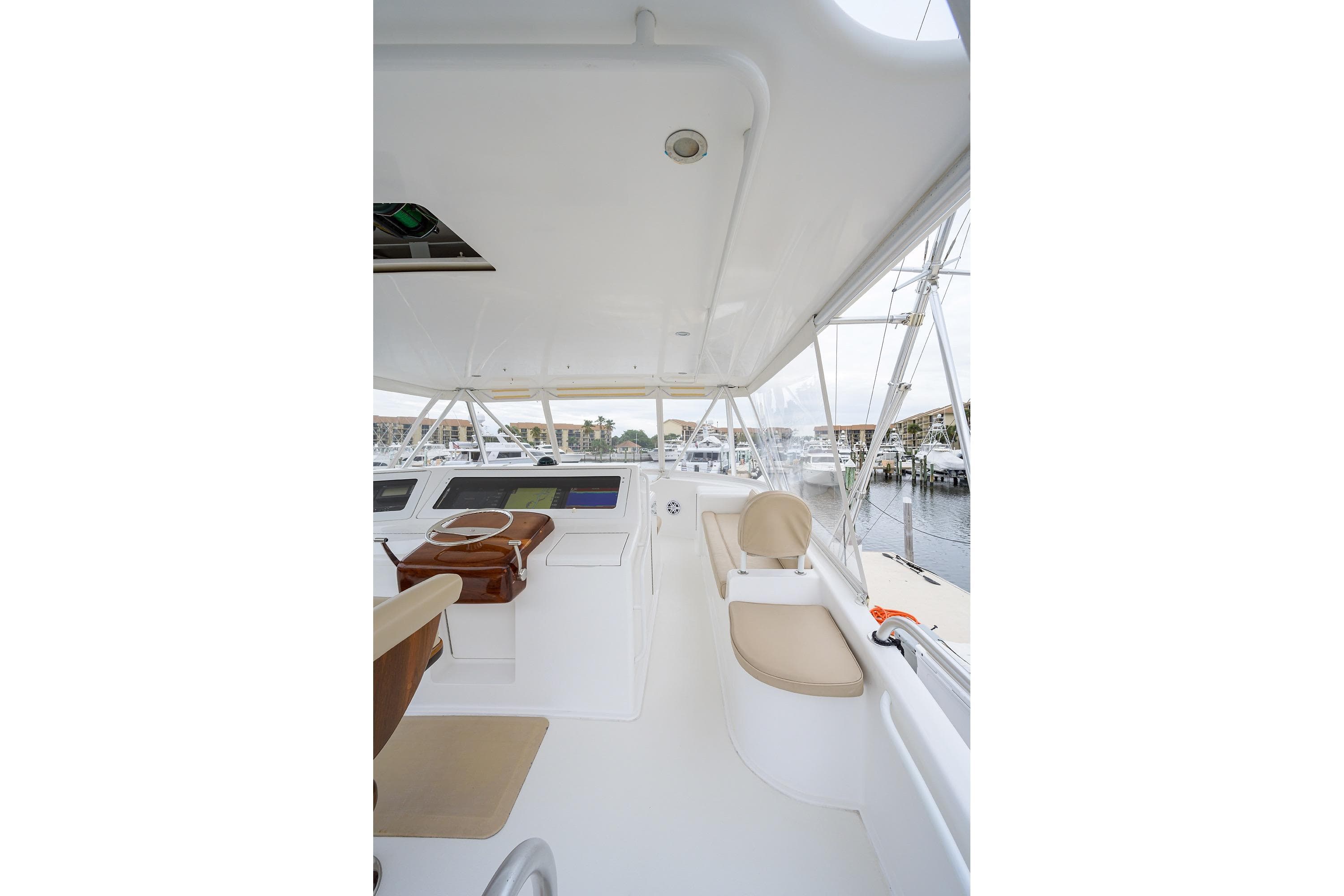 2005 Viking 61 yacht helm with beige seating and marina view.