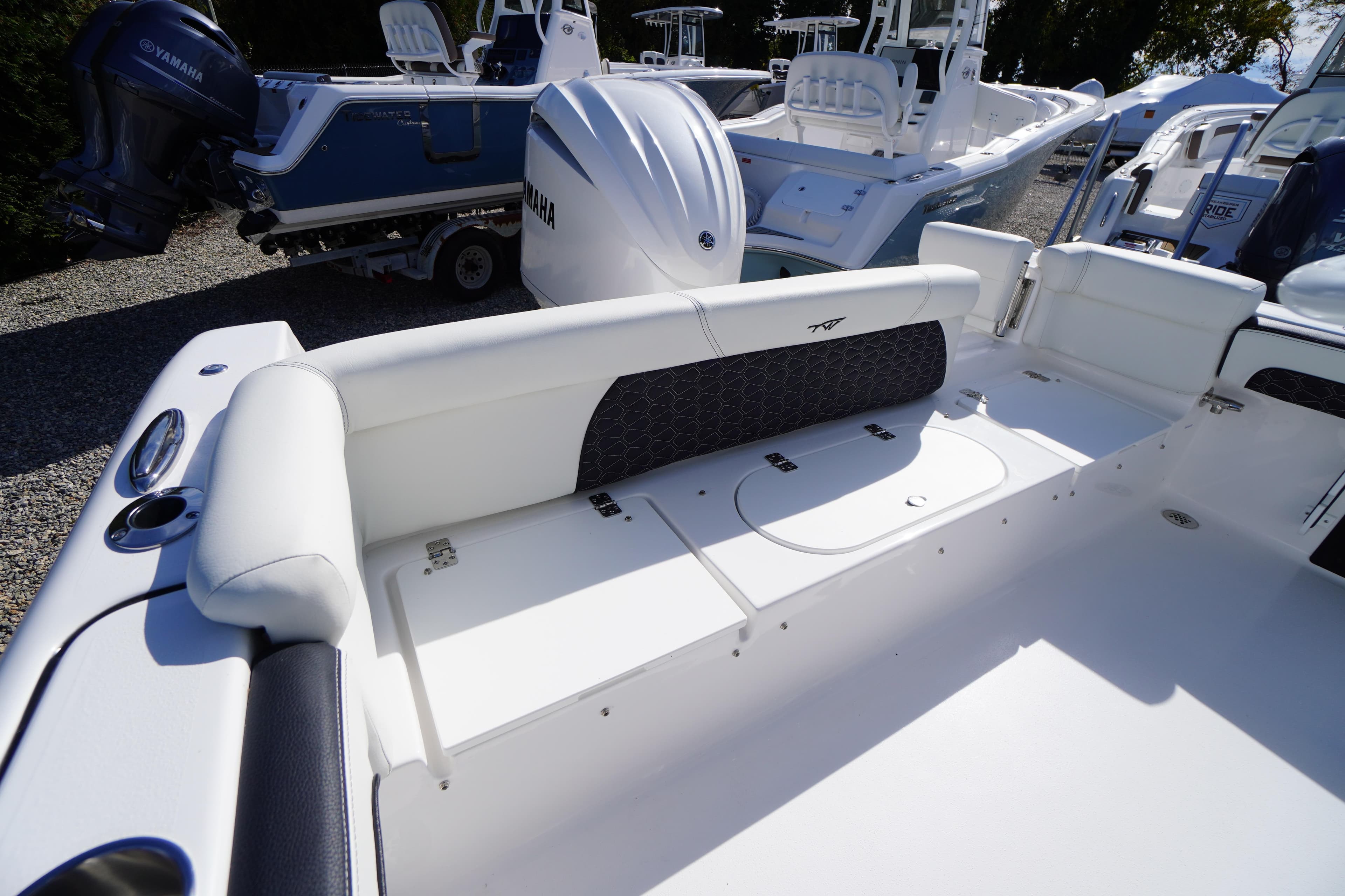 2026 Tidewater 220 LXF boat interior with white seating and Yamaha engine.