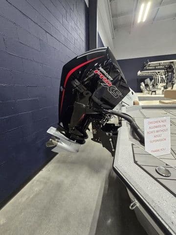 2025 Vexus ACX2210 boat with powerful outboard motor in showroom setting.