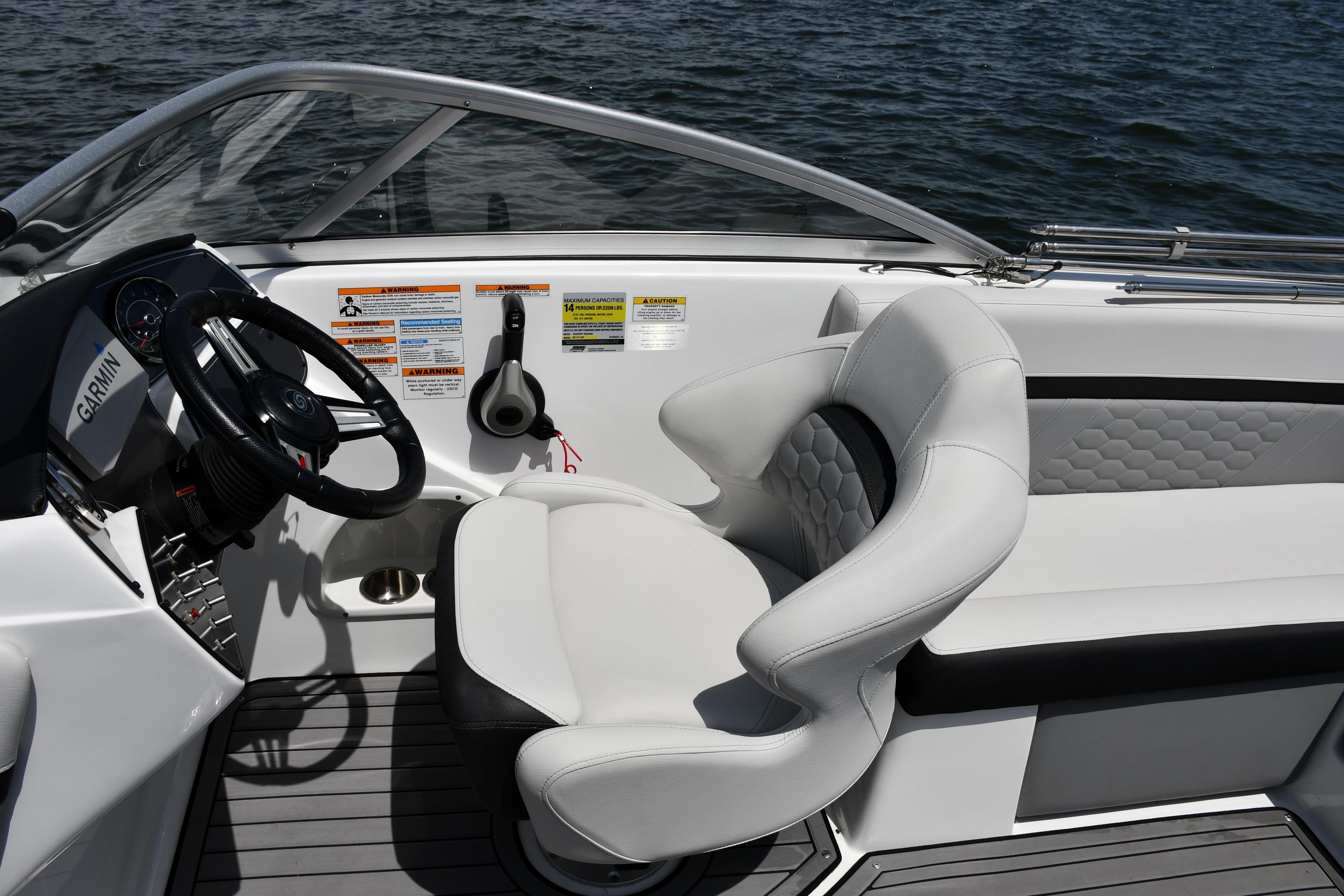 2023 Hurricane SunDeck 217 OB boat interior with steering wheel and comfortable seating.