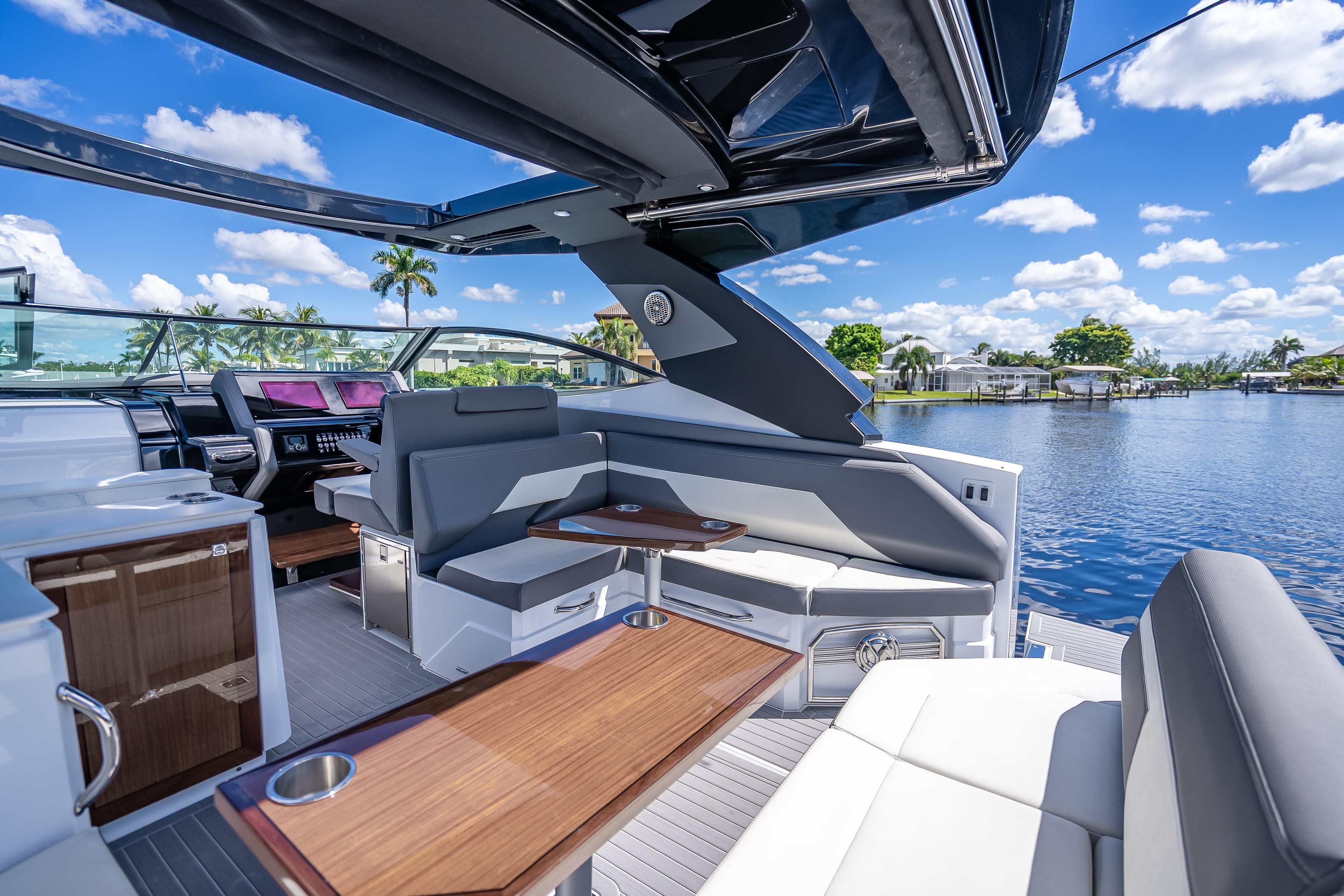 Luxurious 2022 Cruisers Yachts 38 GLS OB interior with sleek seating and scenic water view.