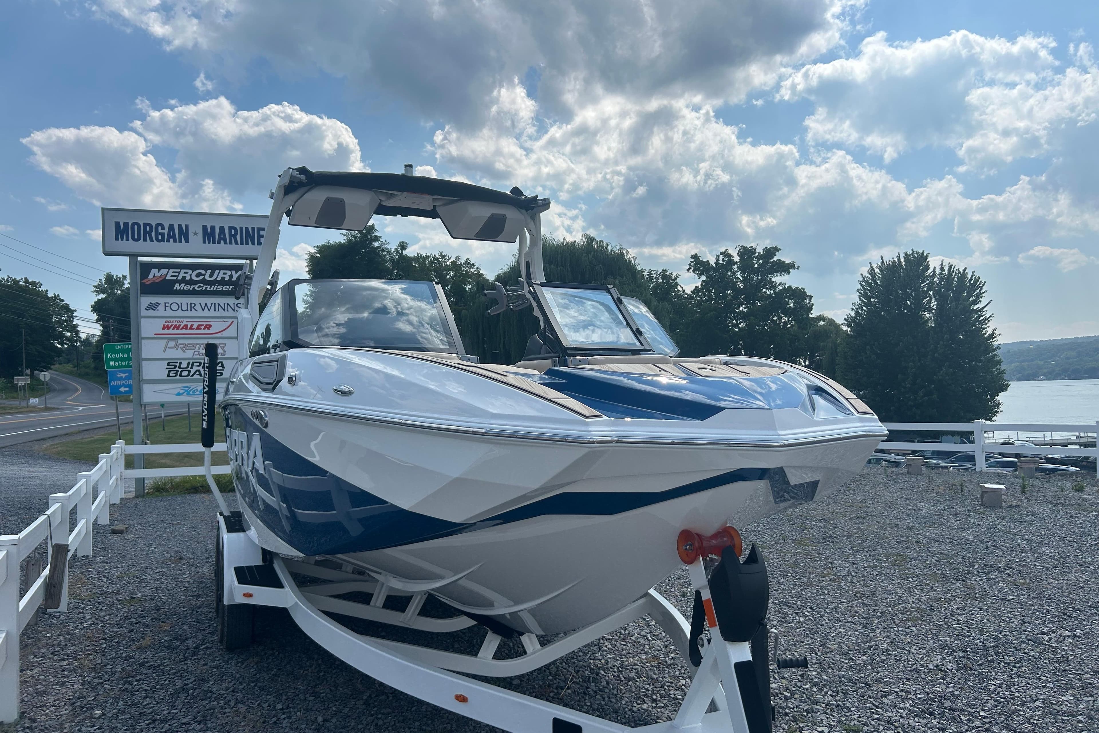 2025 Supra SV boat at Morgan Marine dealership under a partly cloudy sky.