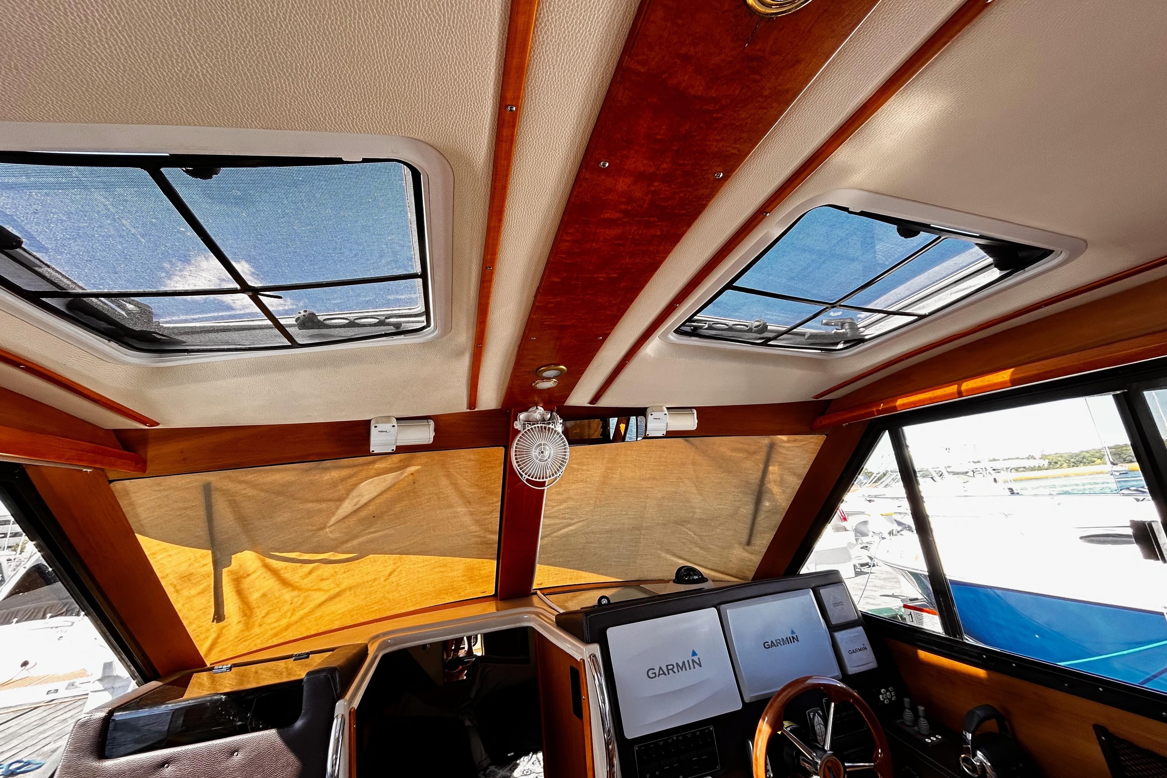 Interior view of 2014 Cutwater C-28 boat cockpit with Garmin navigation screens.