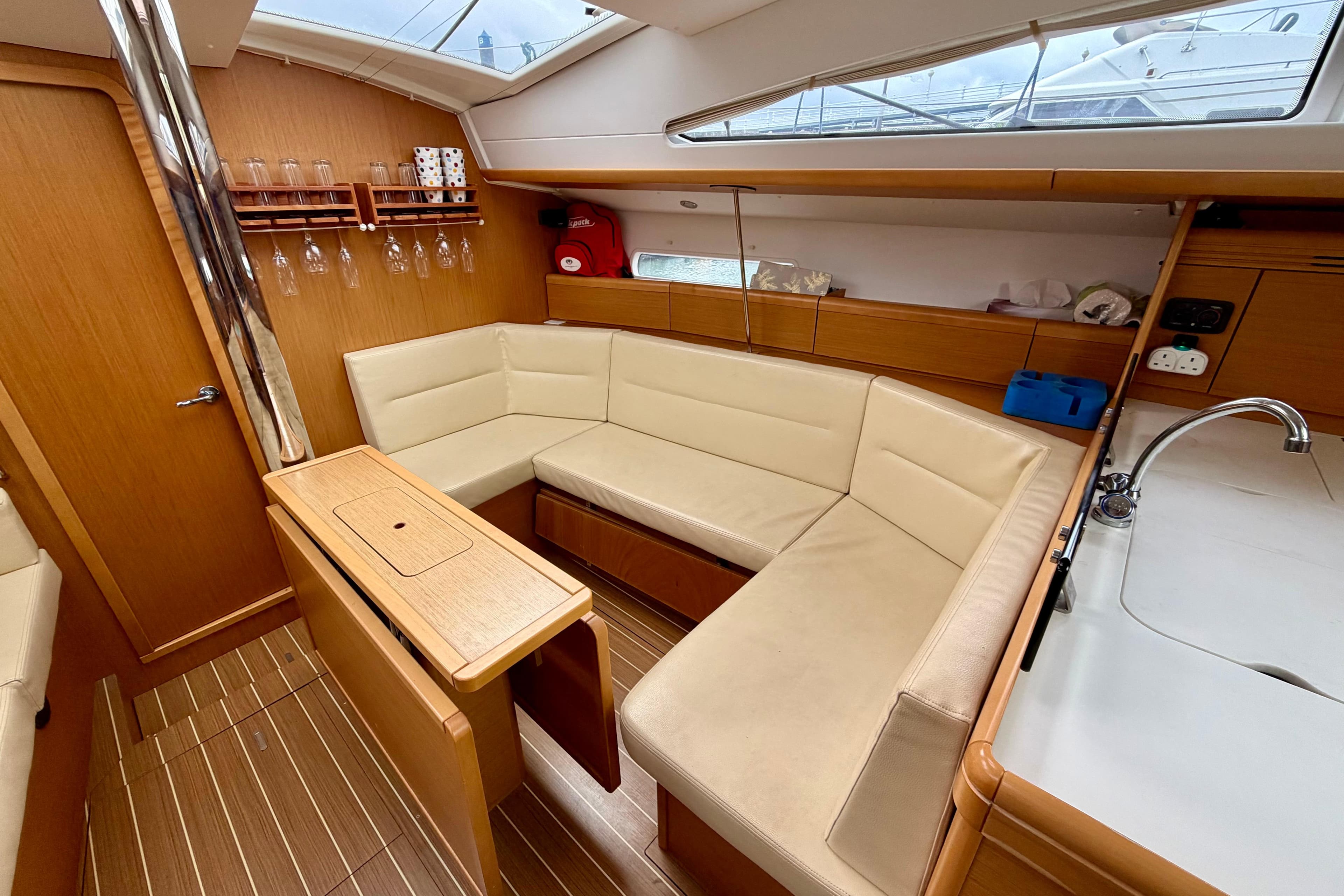 Interior of 2011 Jeanneau Sun Odyssey 42 DS yacht with cozy seating and modern design.