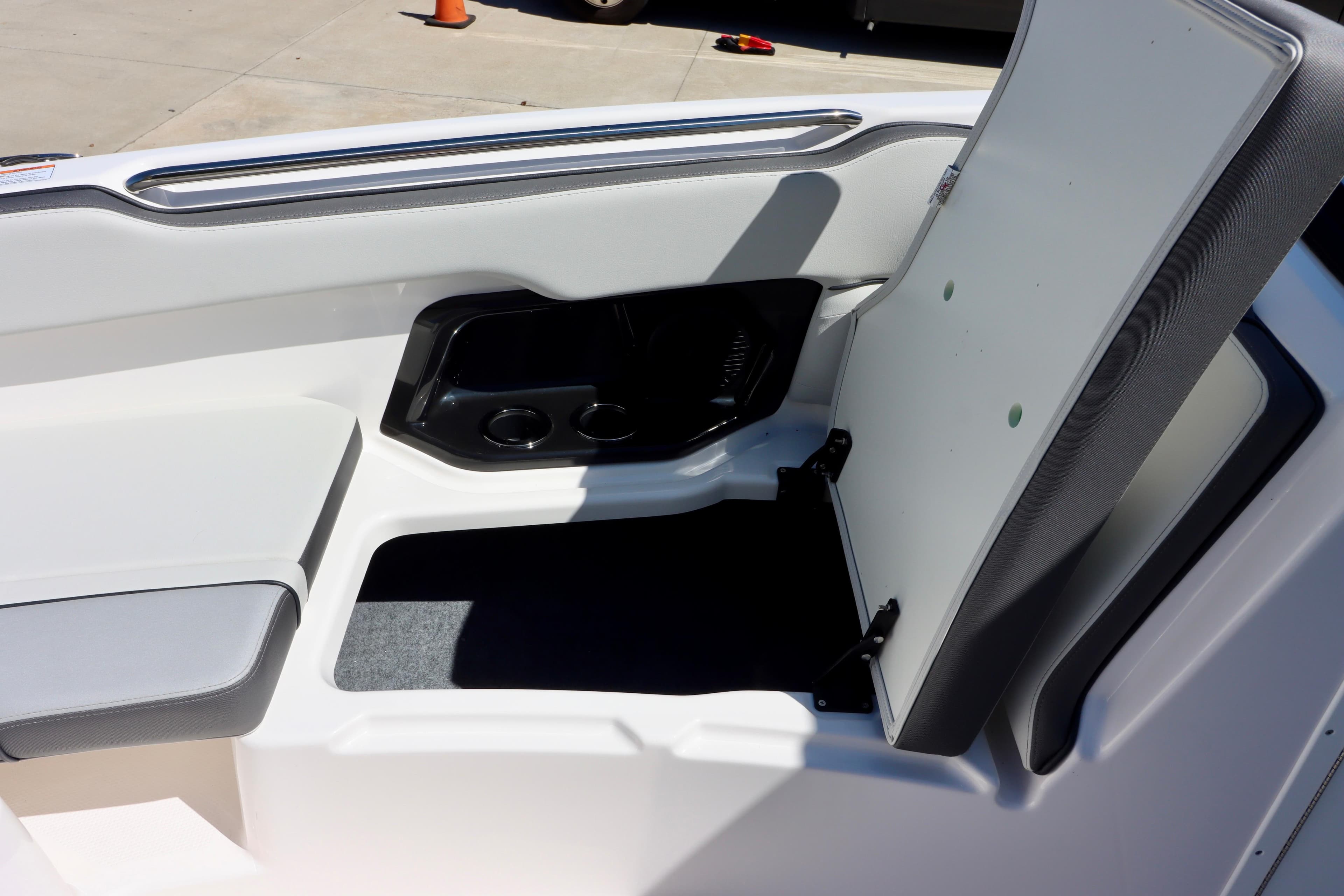 2023 Yamaha AR250 boat interior storage compartment with open lid and cup holders.