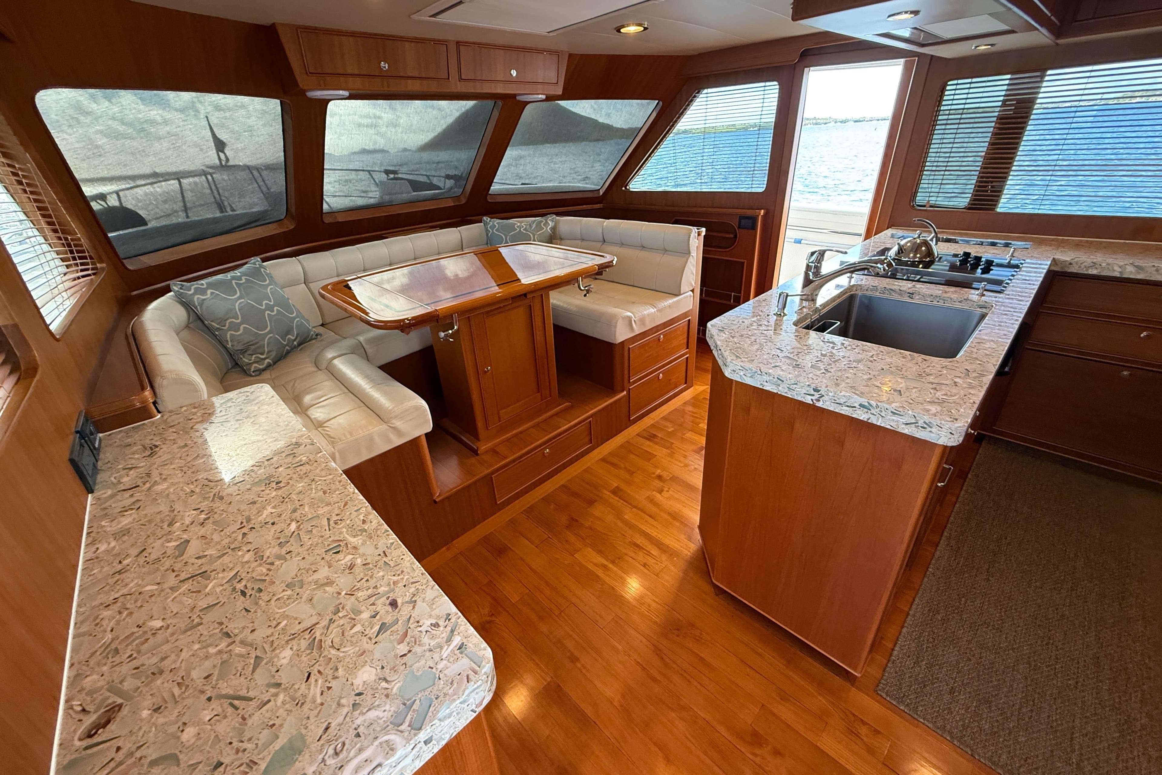 Luxurious 2017 Marlow Explorer 49E yacht interior with elegant wood finishes and modern kitchen.