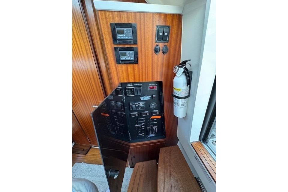 Control panel of 2023 Pursuit S 428 Sport boat with fire extinguisher.