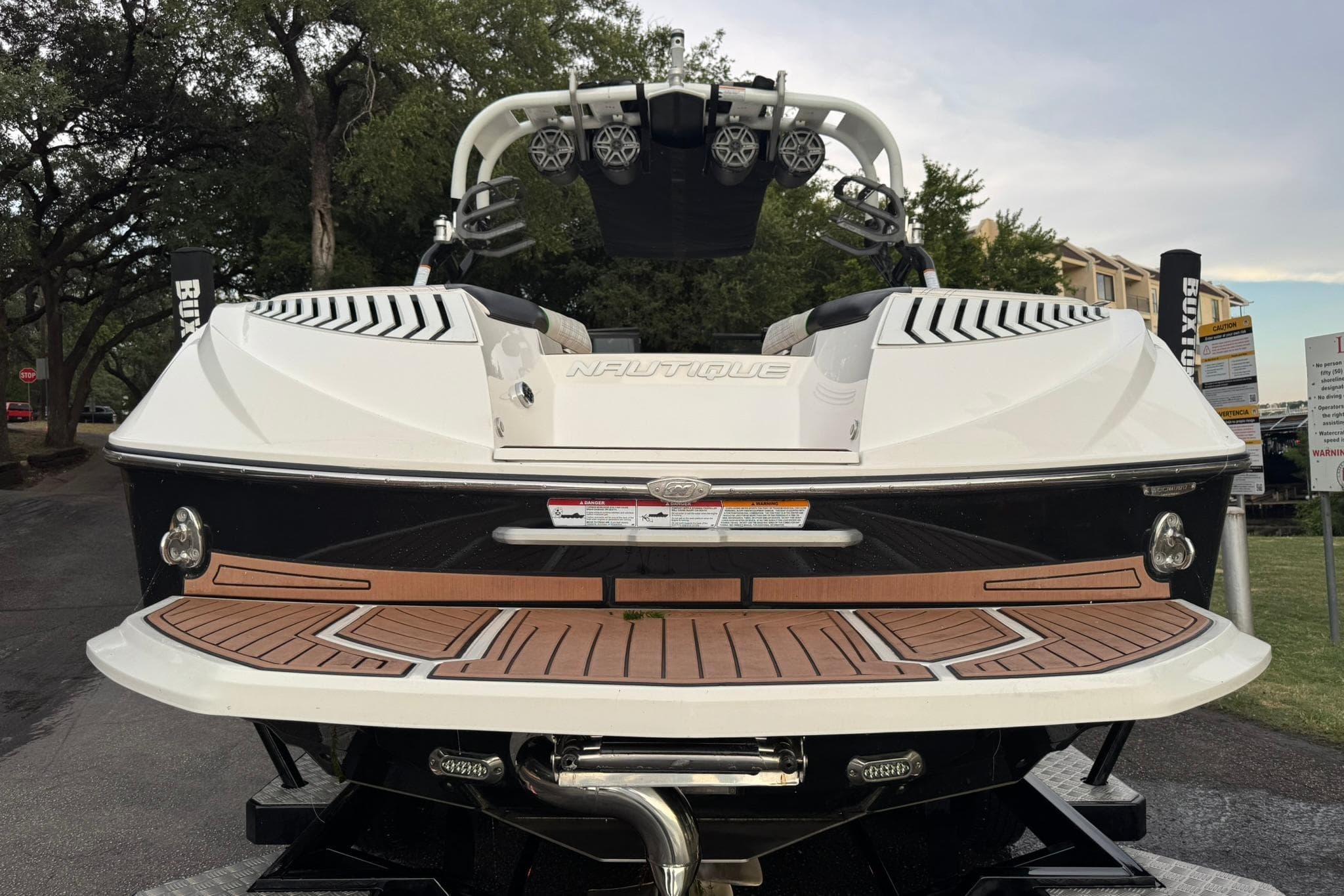 2017 Nautique Super Air Nautique G23 boat rear view with teak deck and speakers.