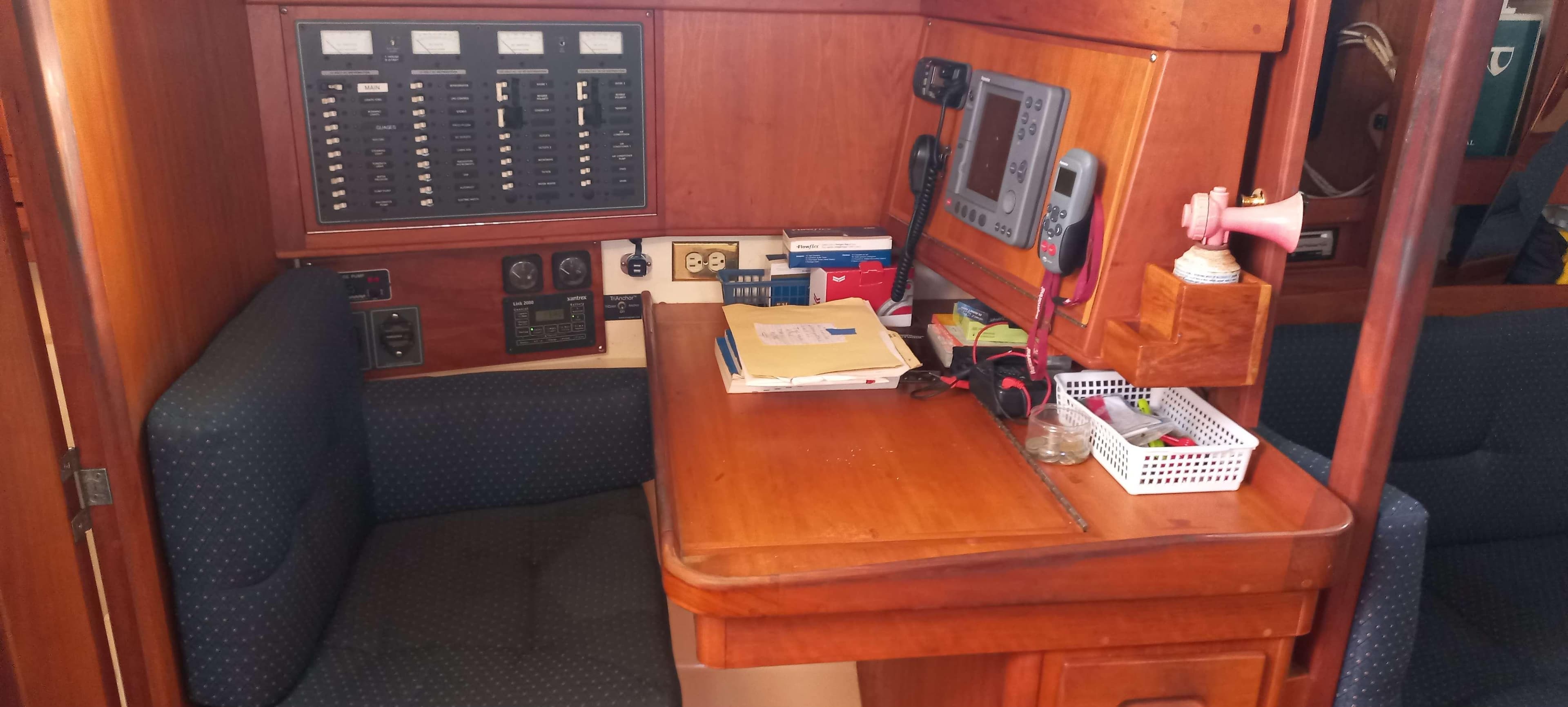 Navigation station in a 2003 Tartan 3700 sailboat with control panels and equipment.