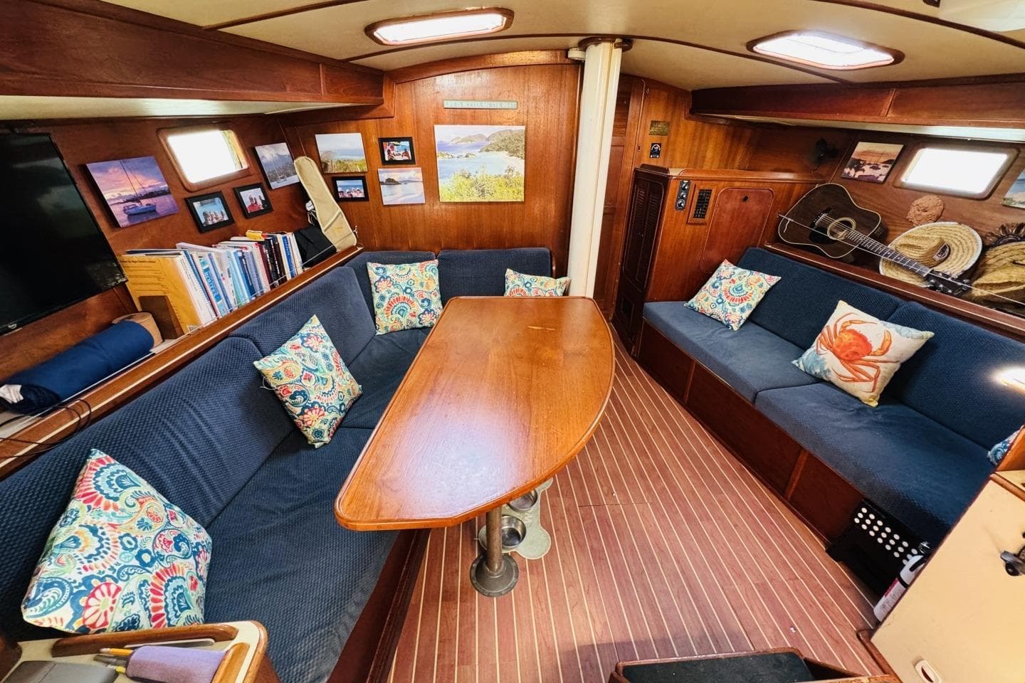 Interior of 1982 Irwin 41 CC Ketch with cozy seating, pillows, and decor.