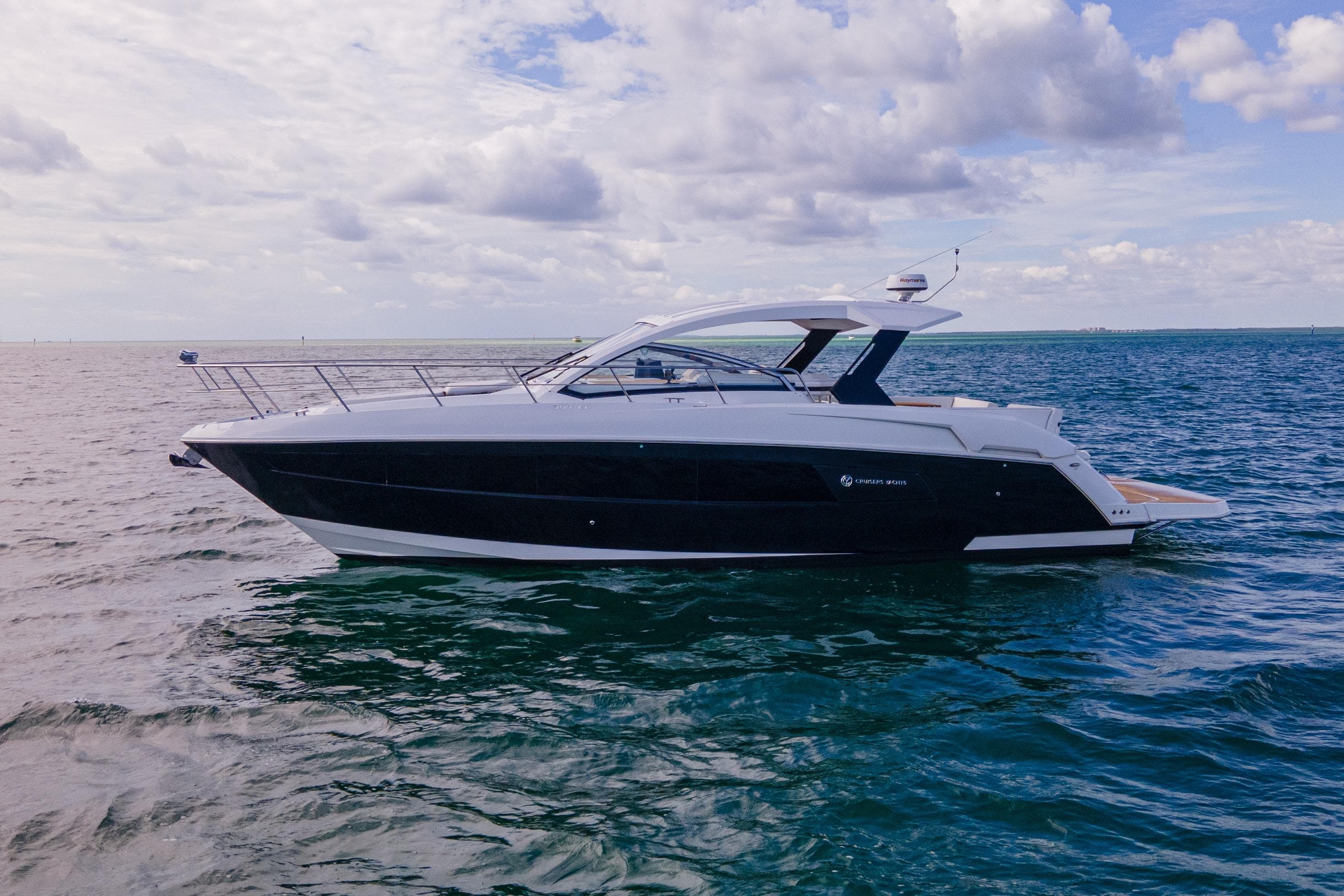 2018 Cruisers Yachts 390 Express Coupe on open water under cloudy sky.
