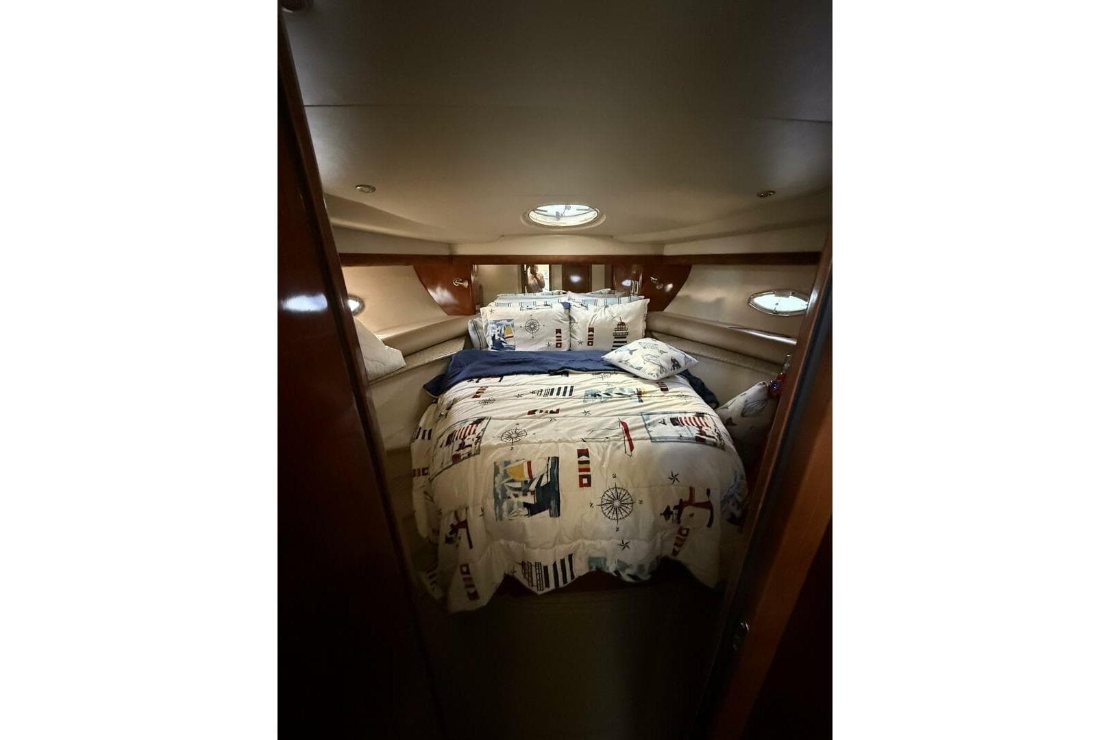 Luxurious cabin interior of 2008 Meridian 459 Motoryacht with nautical-themed bedding.