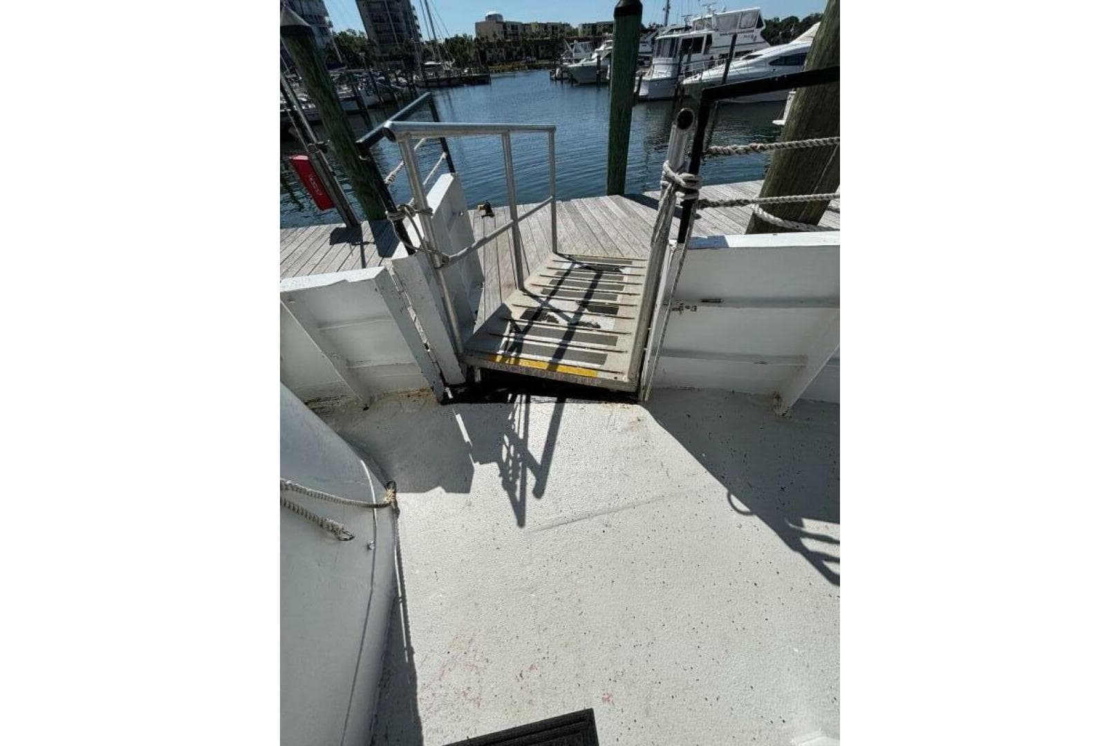 Boat deck with ramp leading to dock, Custom Paddle Wheel, 1984, marina view.