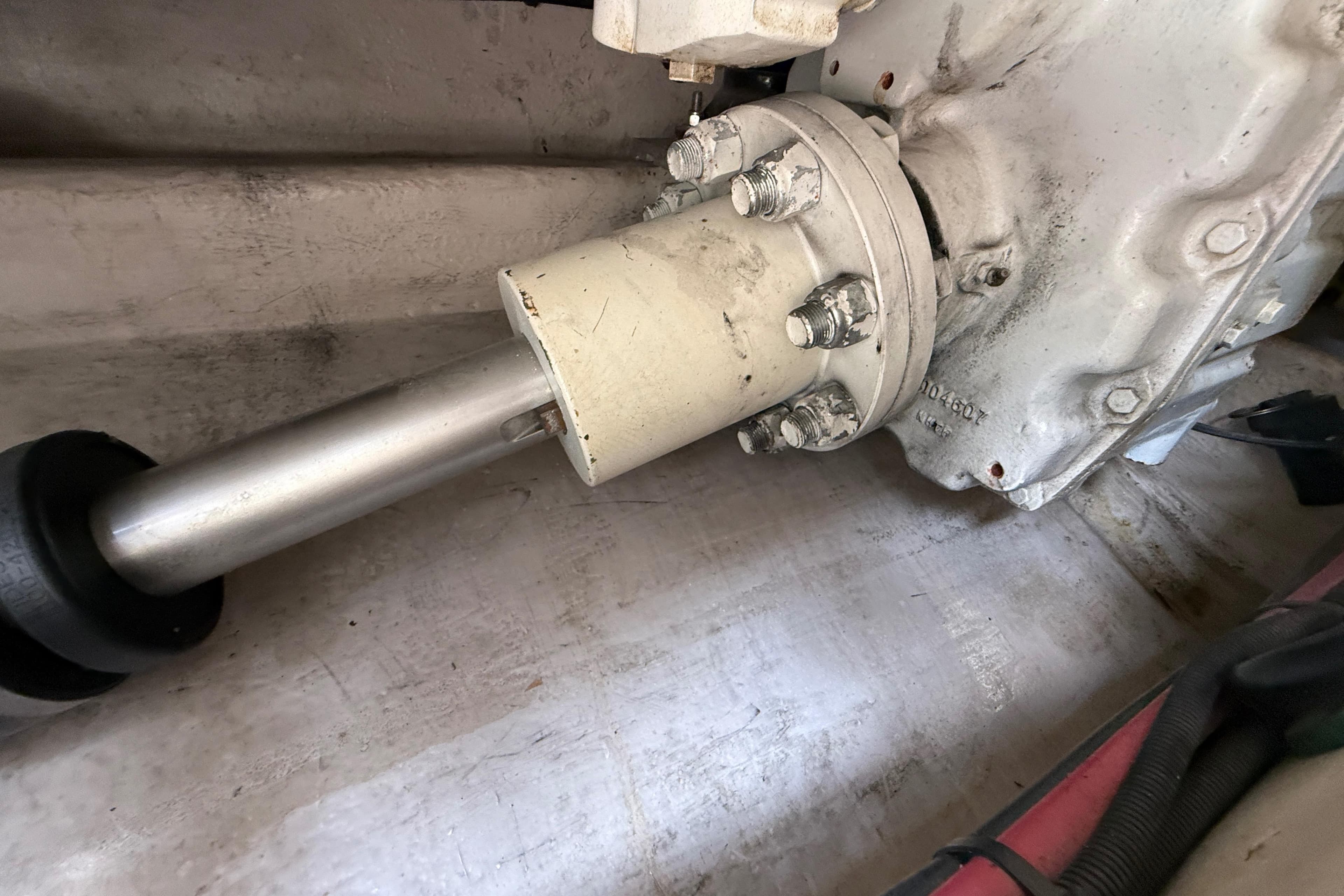 Engine component of a 1998 Sea Ray 500 Sundancer boat, showing shaft and bolts.