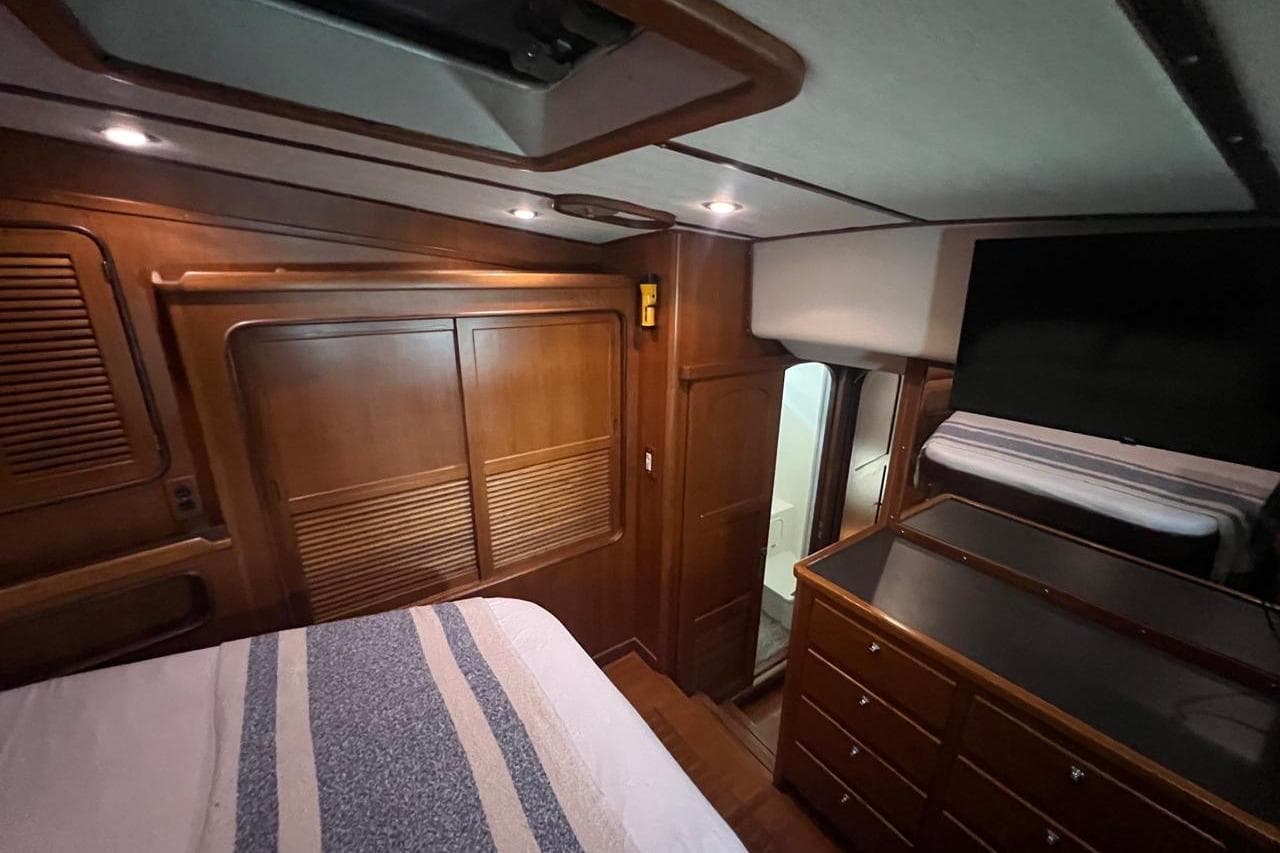 Luxurious 1998 Nordhavn 46 yacht cabin with wooden interior and modern amenities.