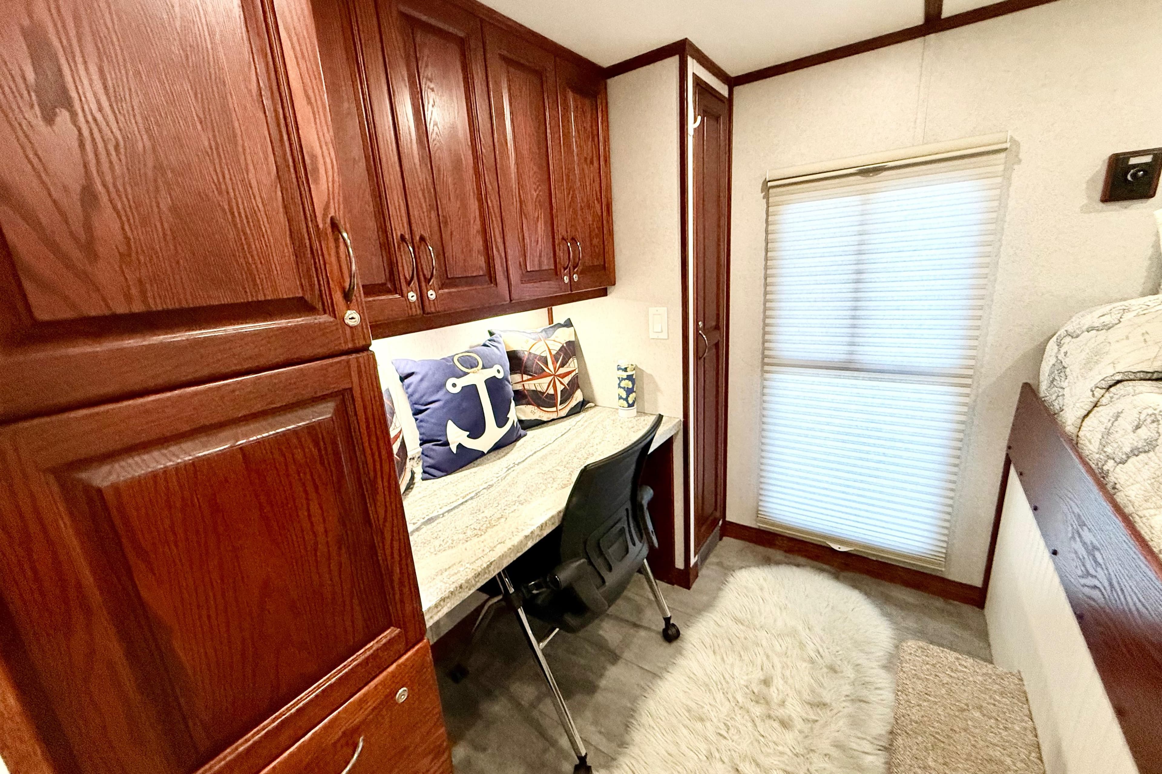 Cozy interior of 2005 Twin Anchors Yacht House with wooden cabinets and nautical decor.