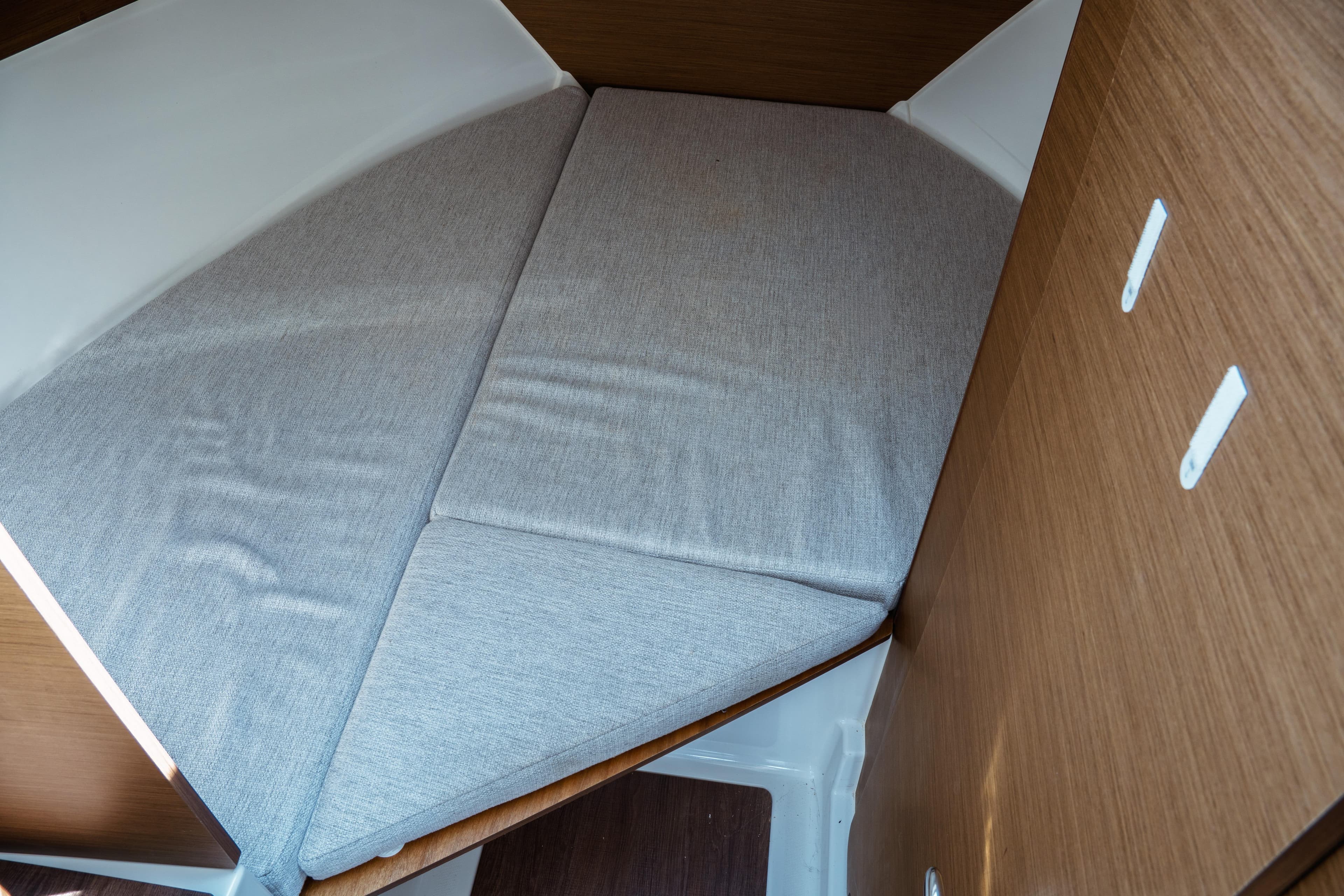 2023 Jeanneau NC Weekender 795 Series 2 cabin interior with cushioned bed.