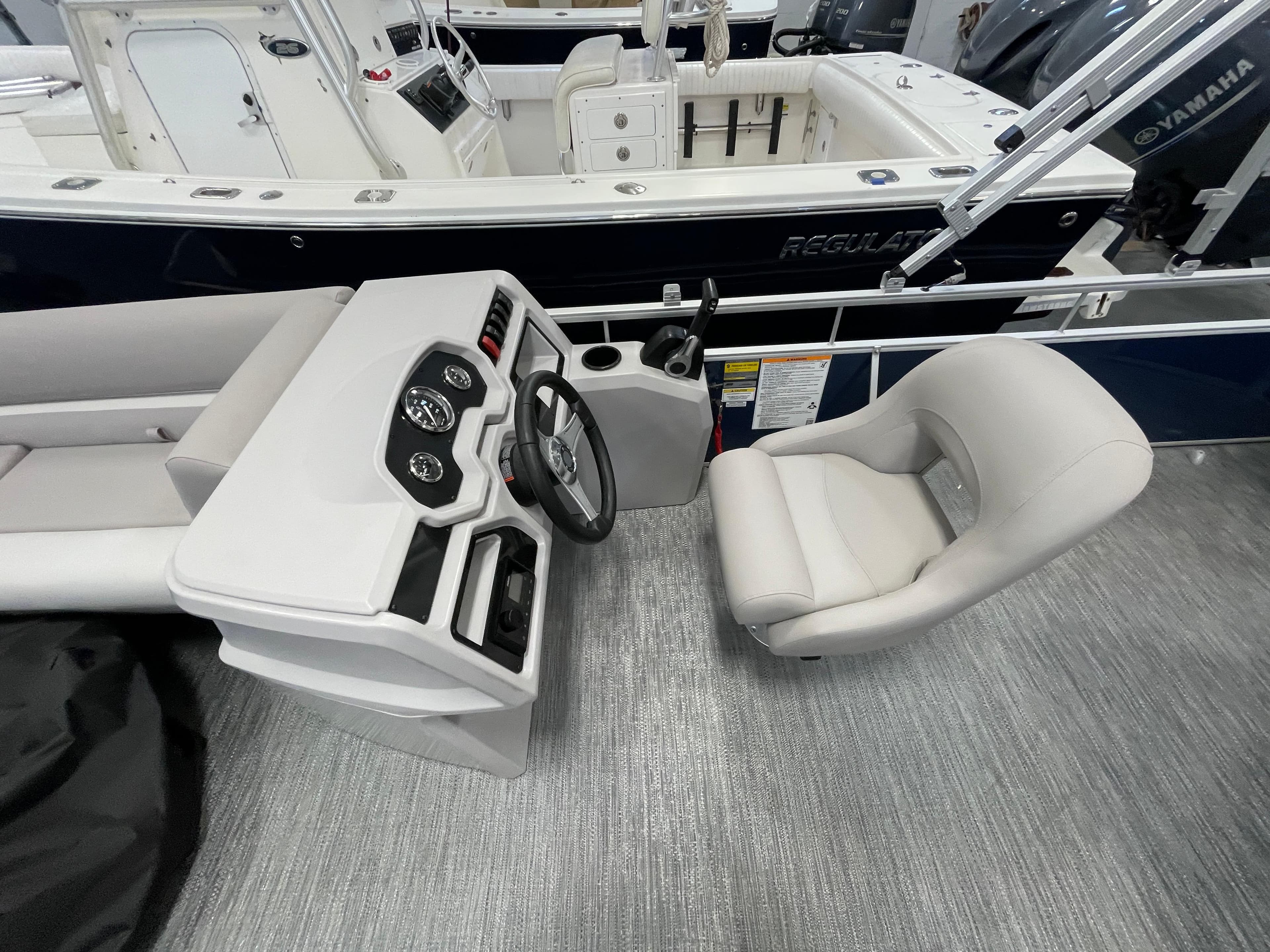2024 Godfrey Xperience 1880 FX boat interior with steering console and captain's chair.