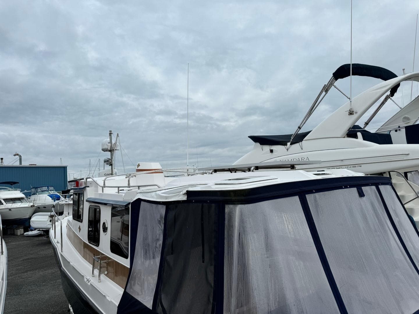 2018 Ranger Tugs R-31S Ranger Tug docked at a marina under cloudy skies.