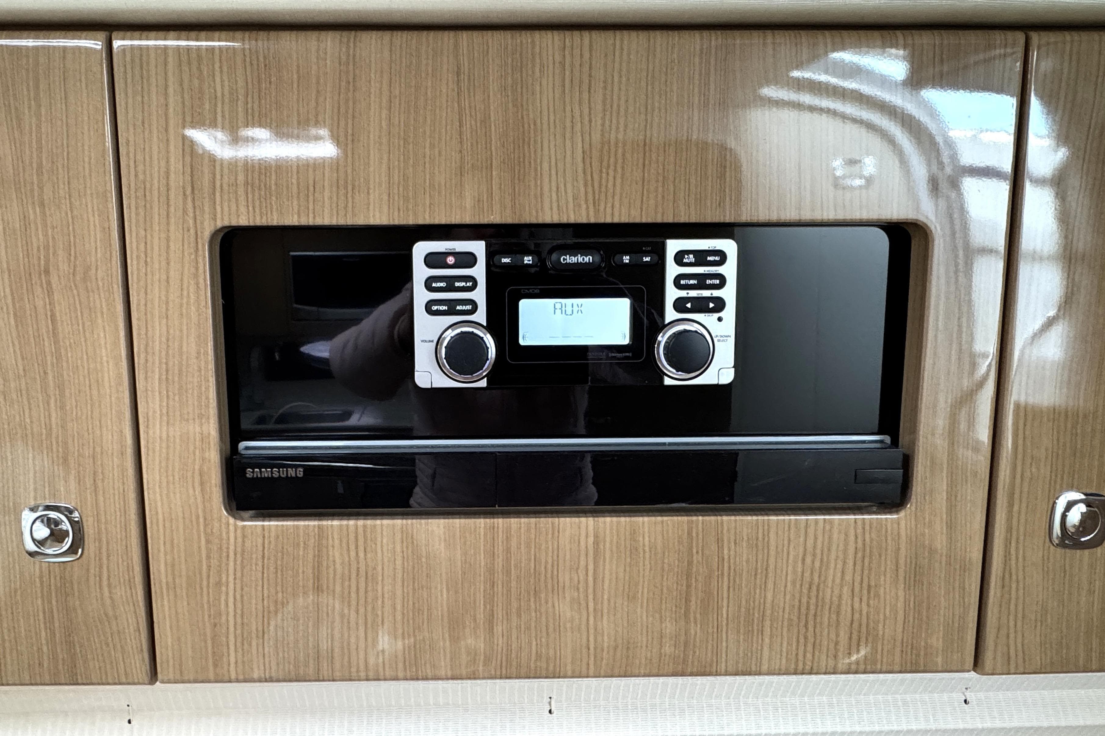 Built-in stereo system in 2016 Formula 34 Performance Cruiser, featuring wood paneling and Samsung components.
