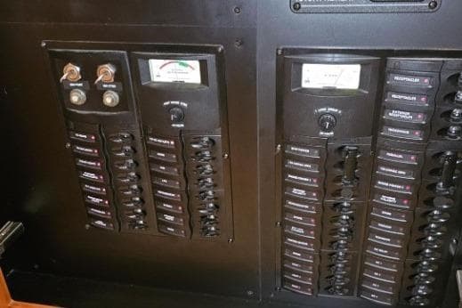 Electrical panel on a 2003 Meridian 381 Sedan boat, featuring switches and gauges.