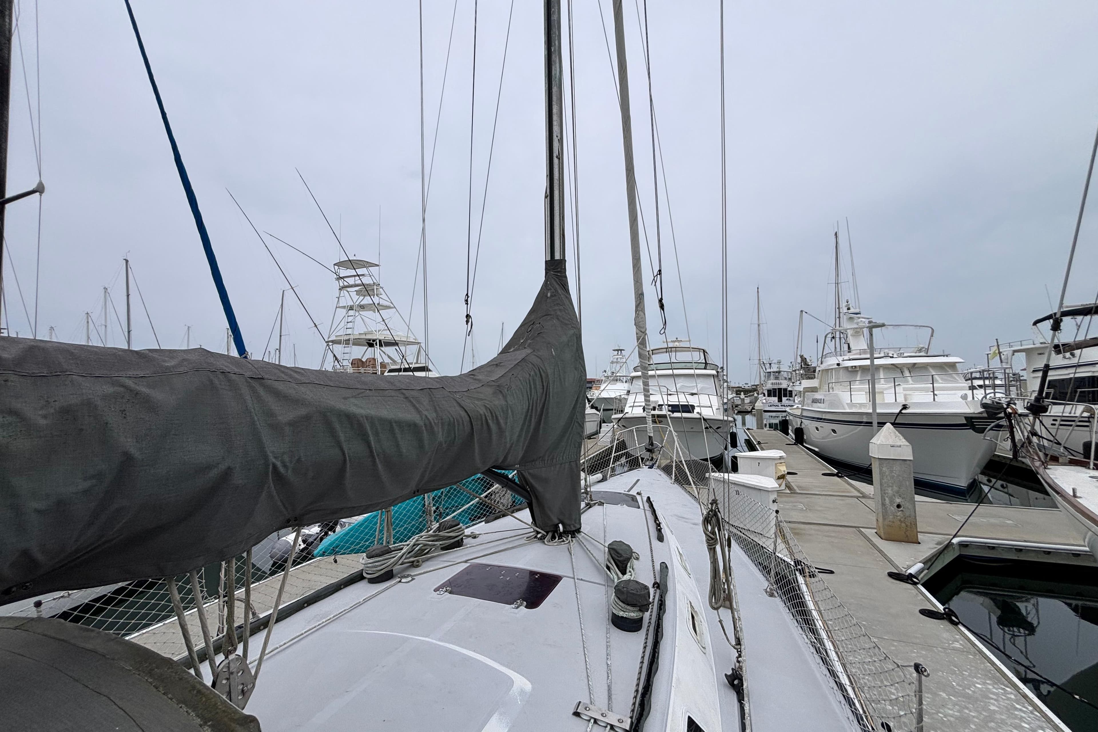 1979 Islander Peterson 40 sailboat docked among other boats in a marina.