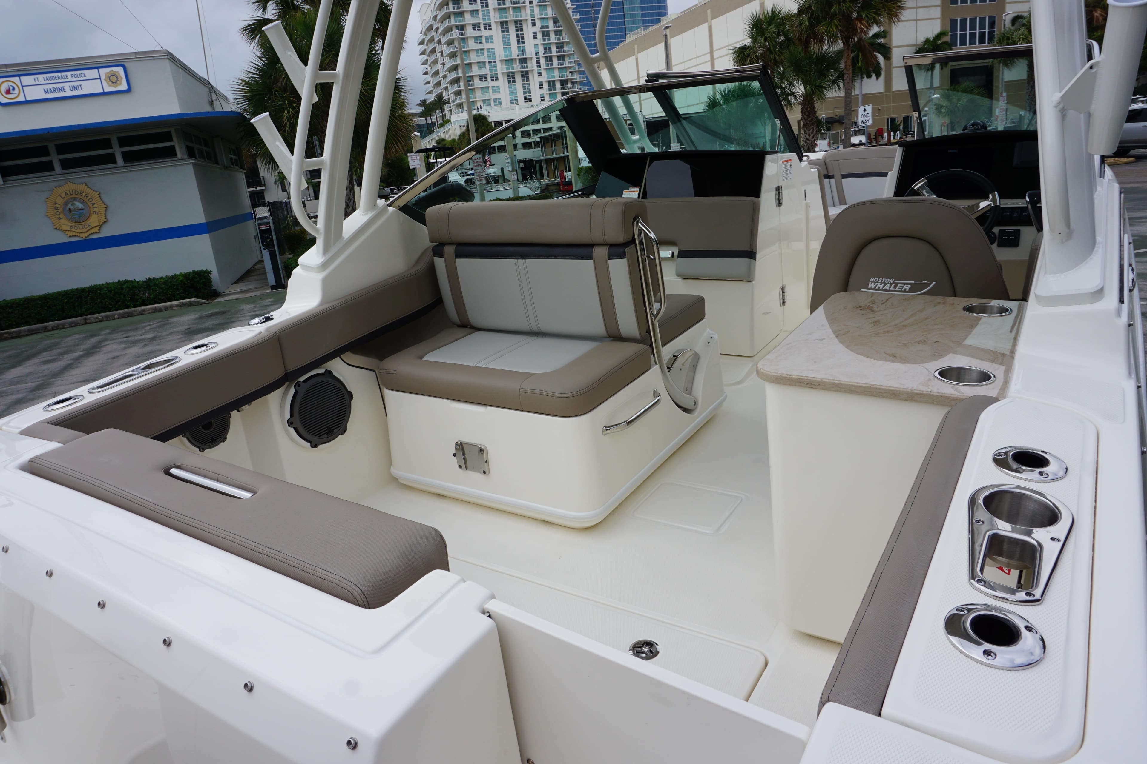 2026 Boston Whaler 240 Vantage boat interior with seating and console, docked near marine unit.