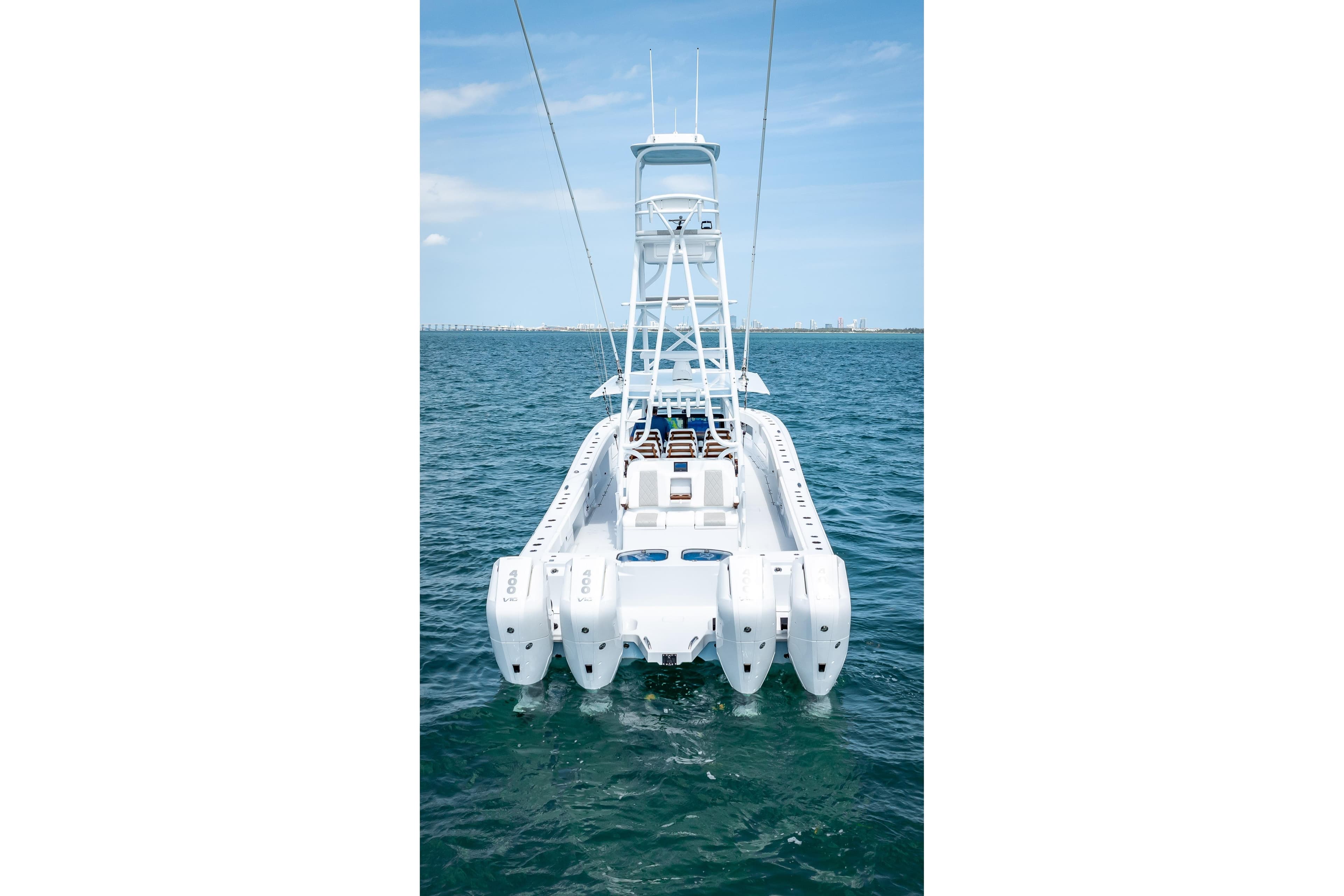 Freeman 43 boat, 2025 model, on open water with clear blue sky.
