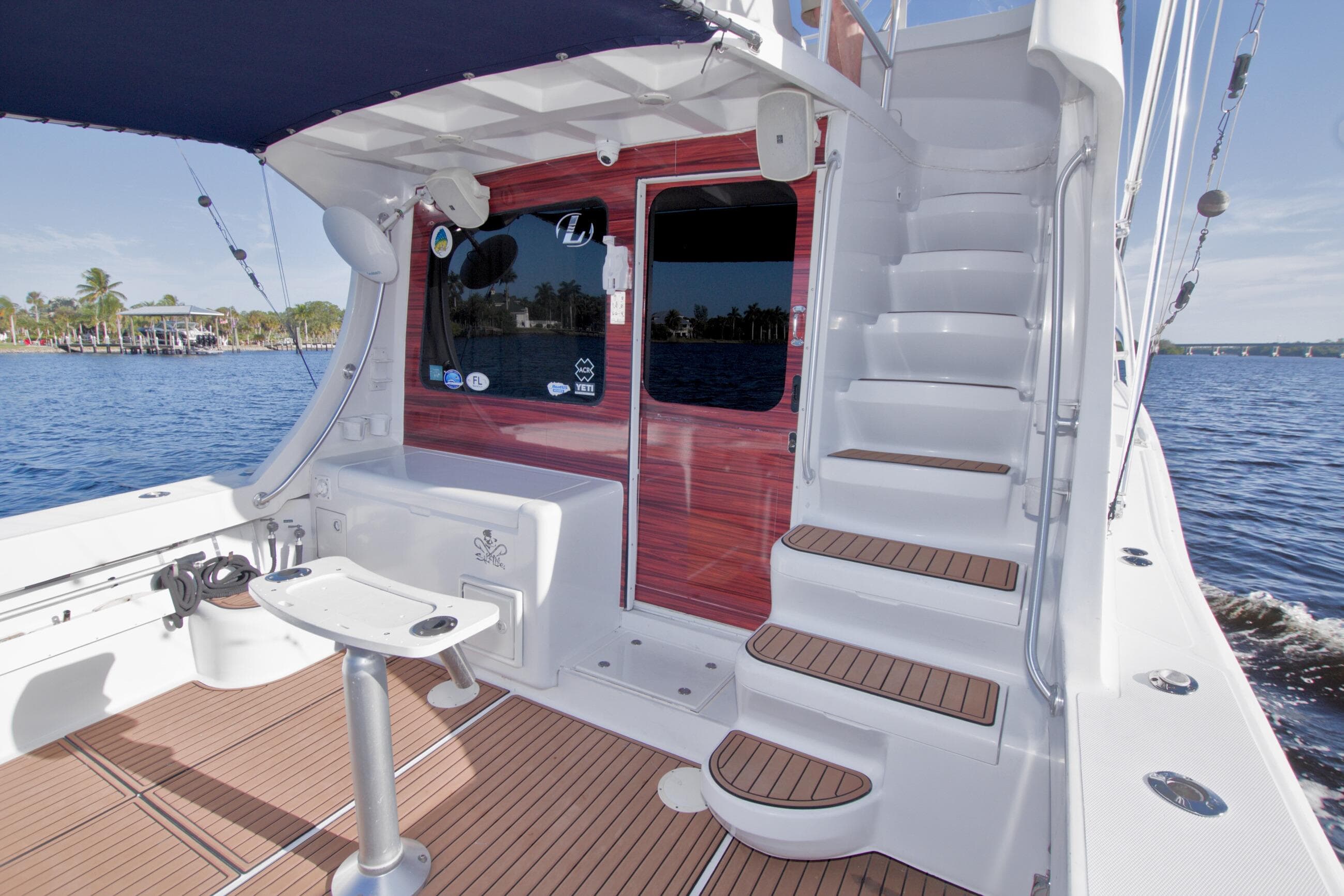 1998 Luhrs 36 Convertible yacht deck with stairs and fishing chair.