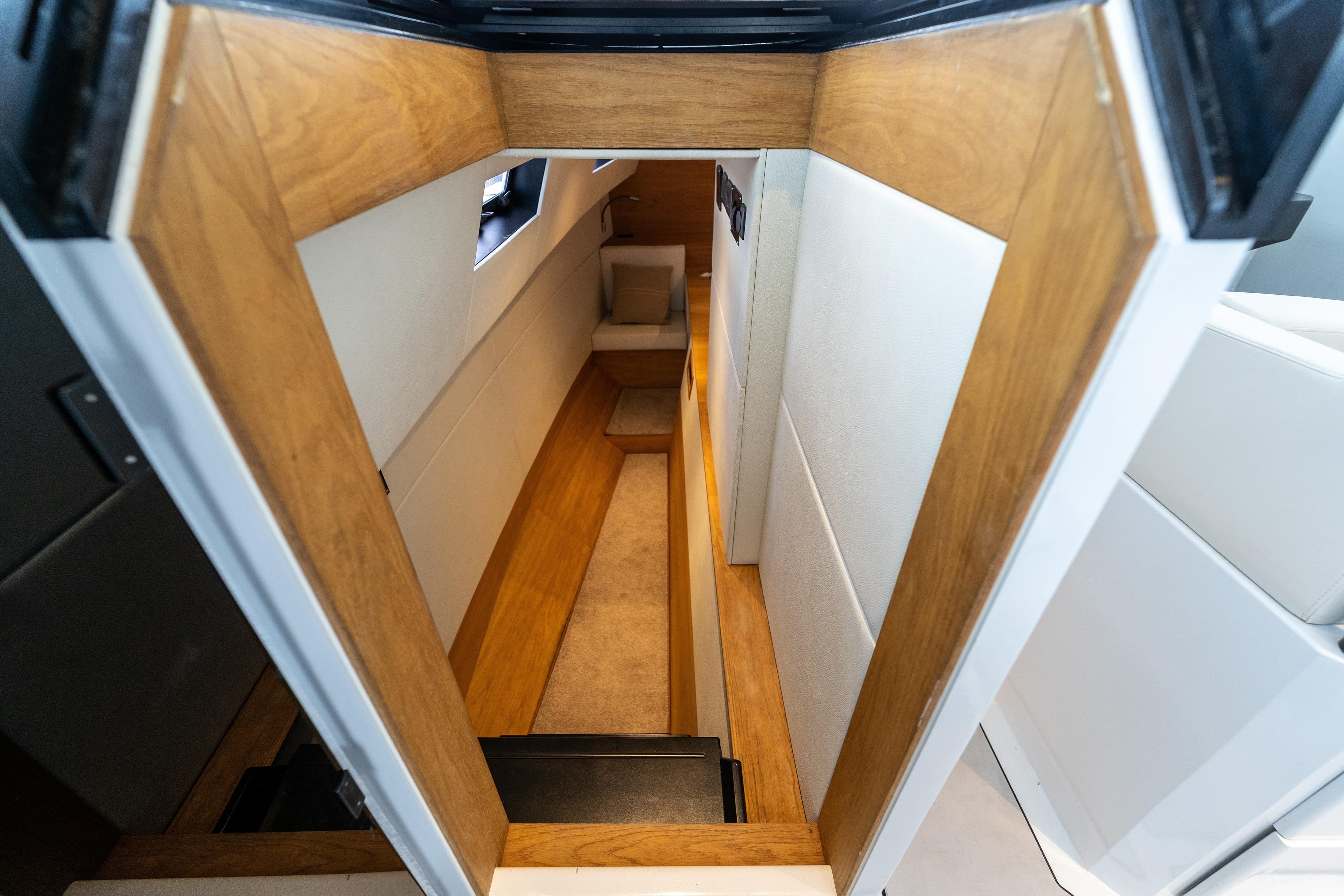 Interior view of 2023 Vandal 46 Explorer yacht, featuring sleek wooden and white paneling.