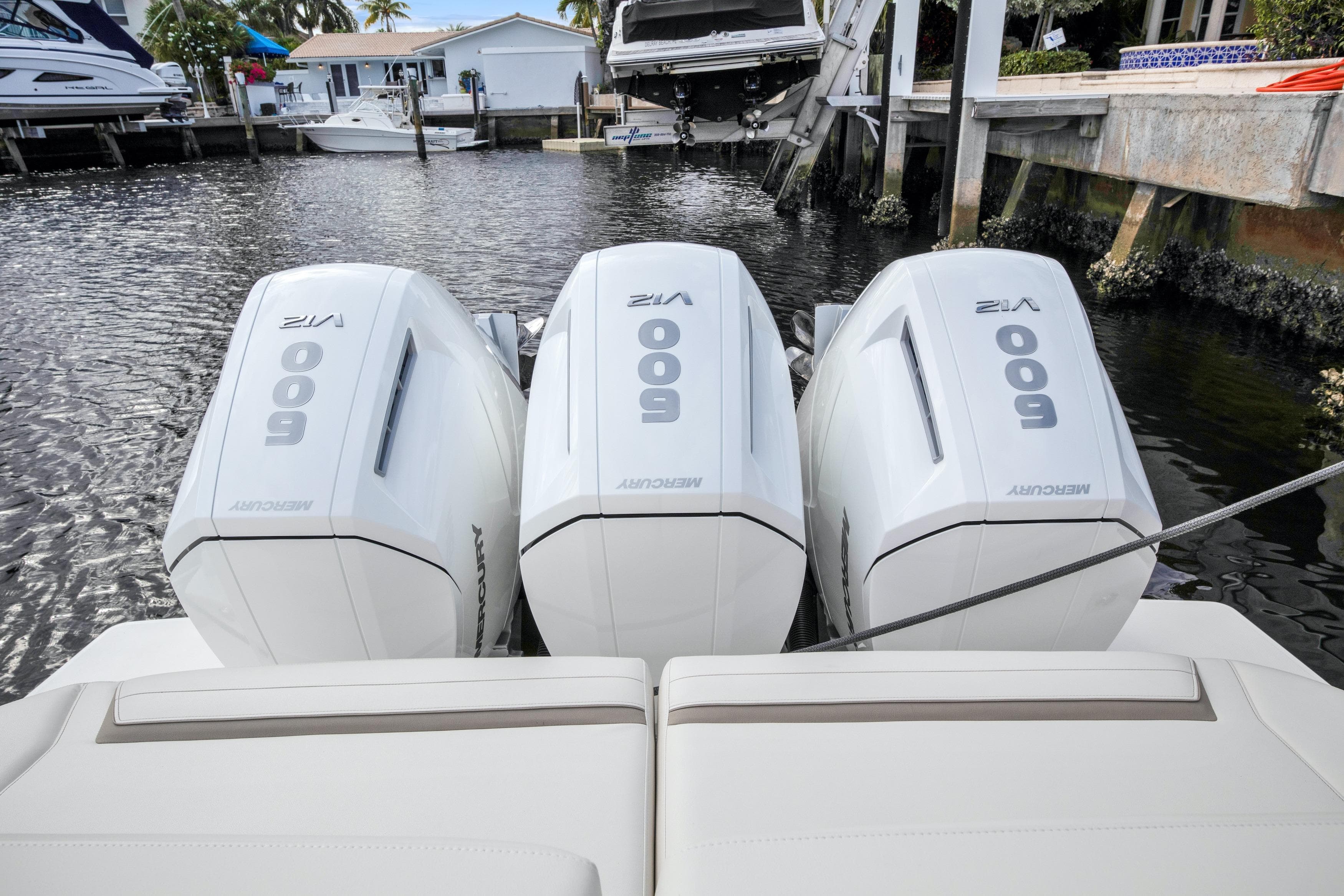 Triple Mercury 600 outboard engines on a 2022 Tiara Yachts 48 LS, docked in a marina.