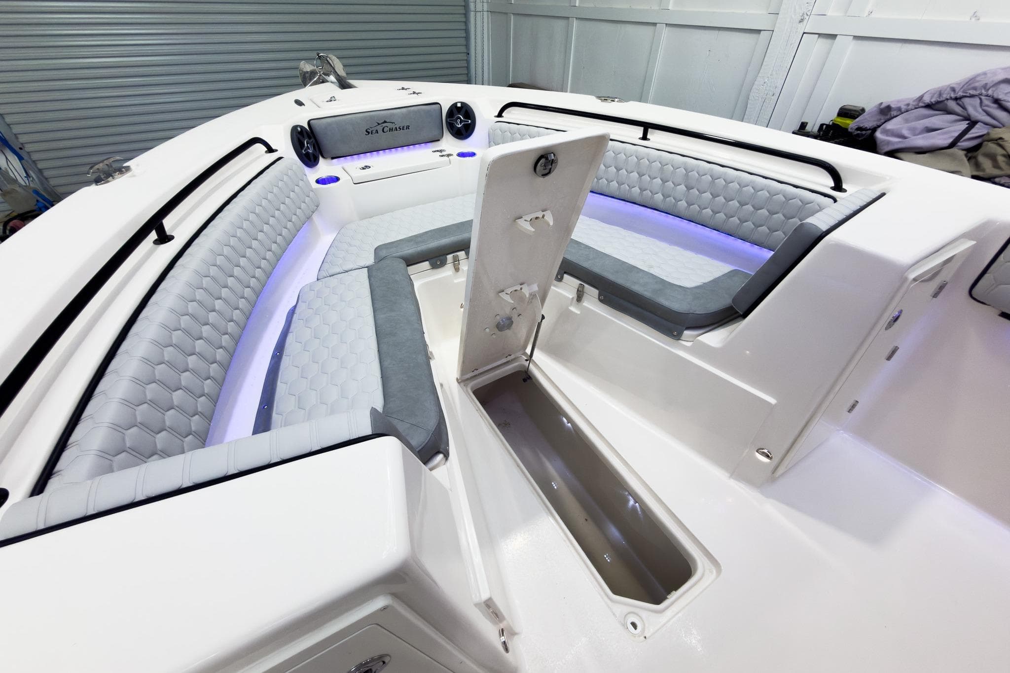 2026 Sea Chaser 27 HFC CC boat interior with cushioned seating and storage compartment.