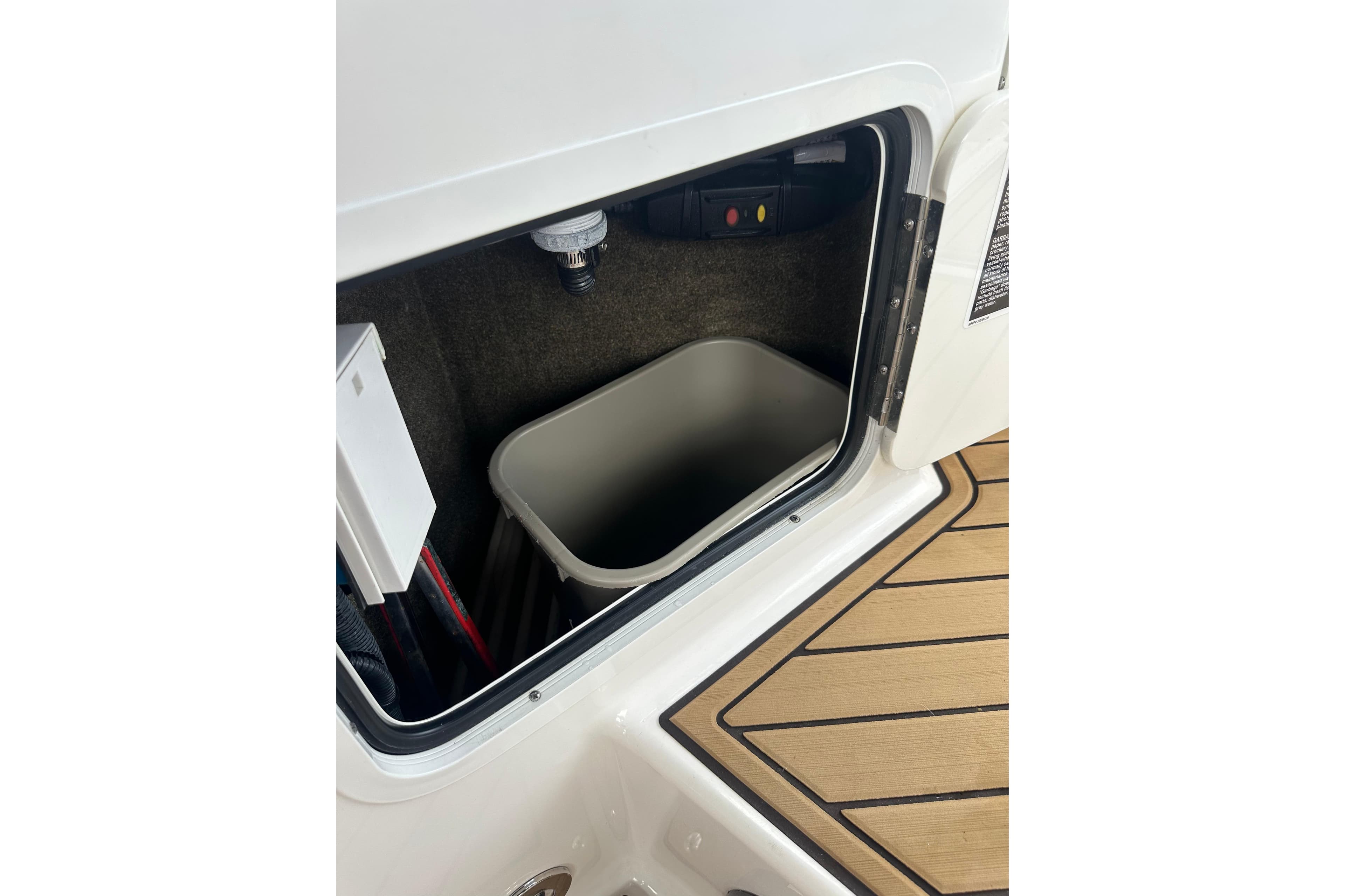 Storage compartment on 2022 Sea Ray SDX 290 boat, featuring a built-in container.