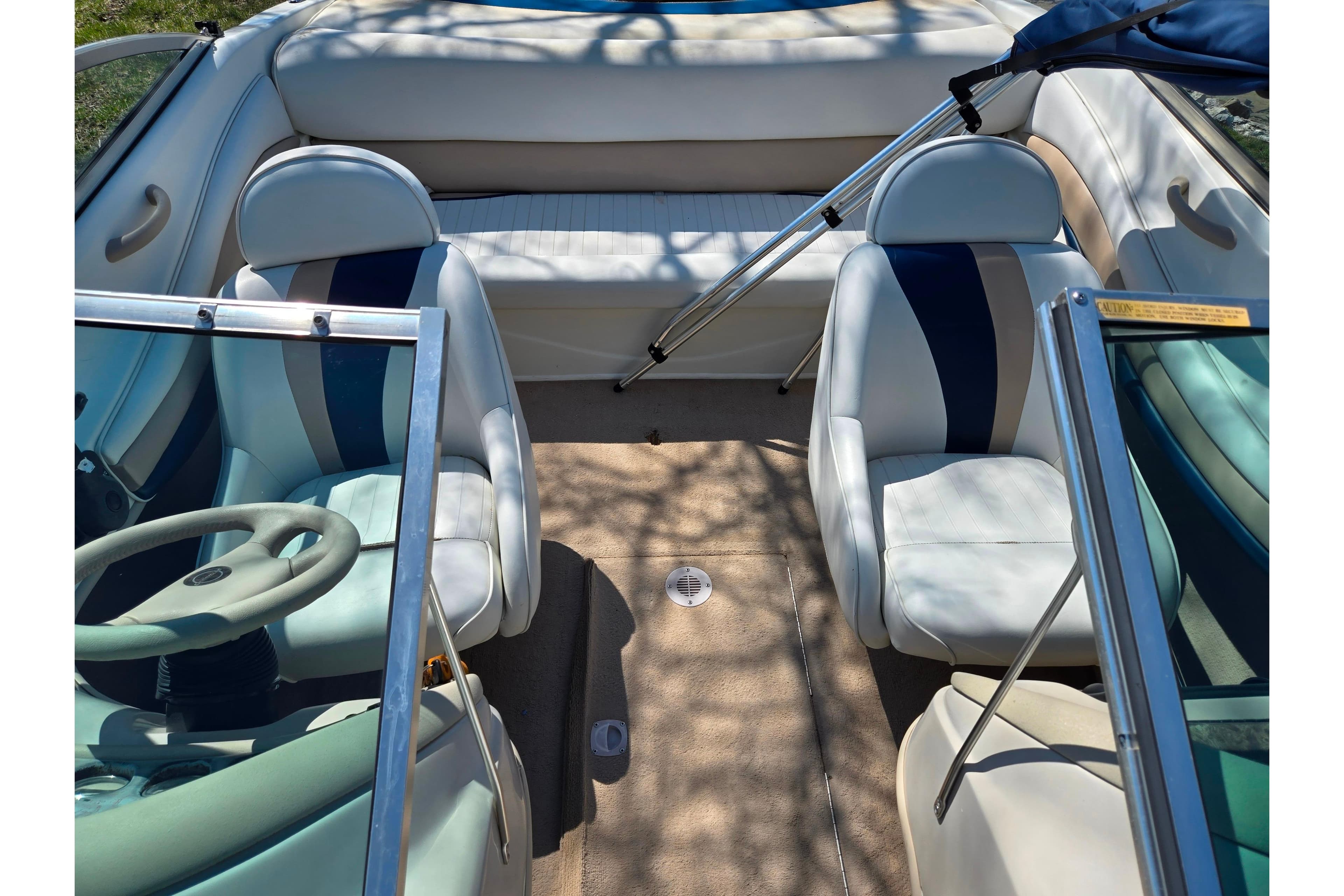 2001 Caravelle 188 Bow Rider interior with white and blue seating.