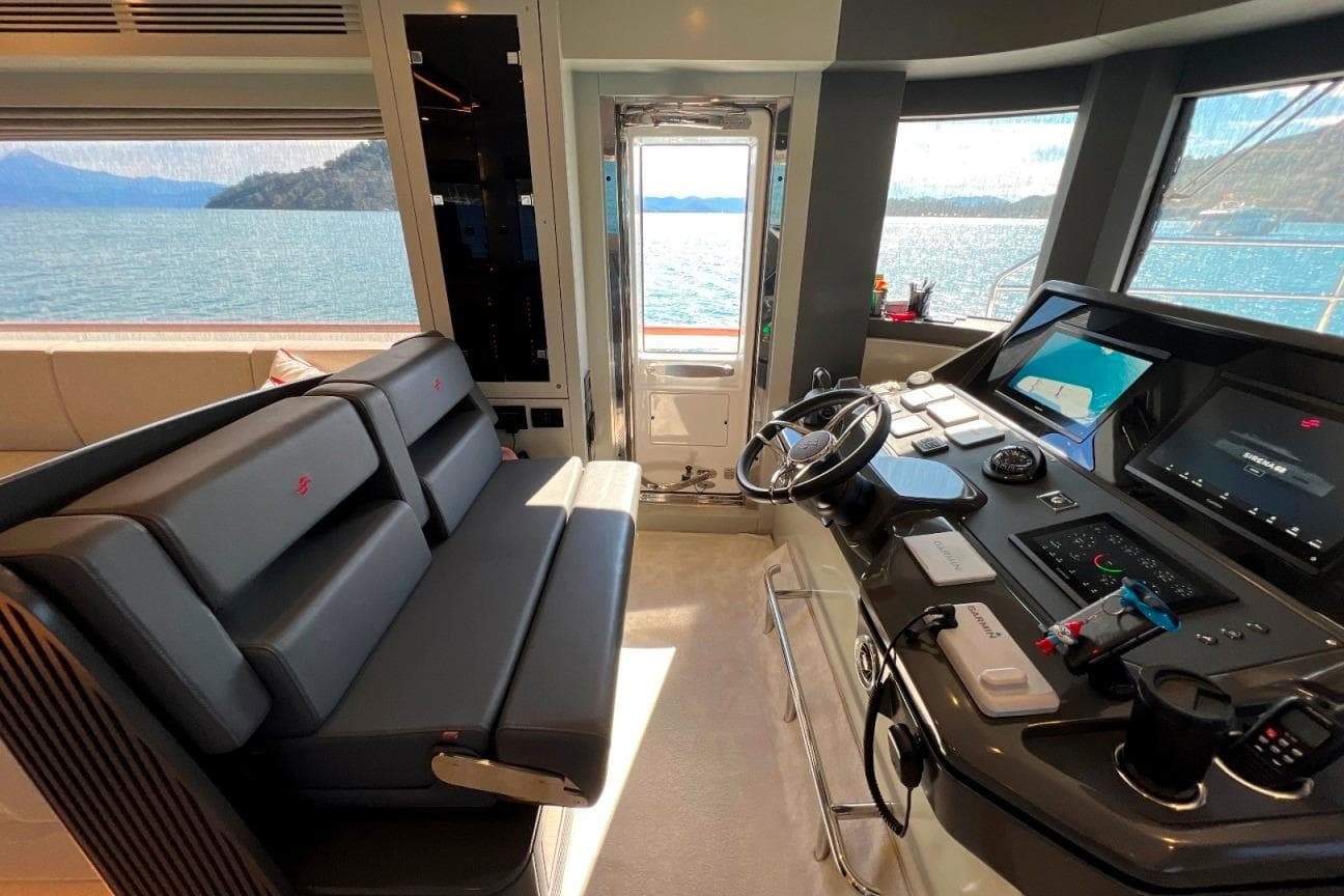 Luxurious helm of 2024 Sirena 68 yacht with panoramic ocean views.