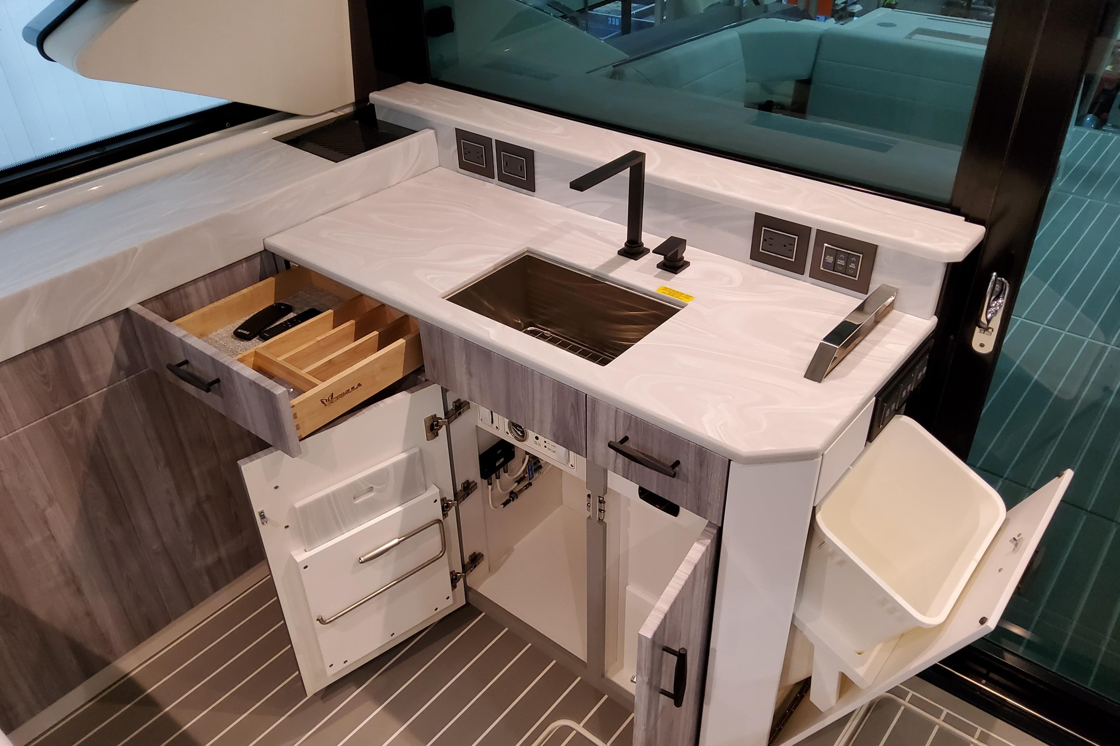 Modern kitchenette in 2026 Formula 500 Super Sport Crossover yacht, featuring sleek design and ample storage.